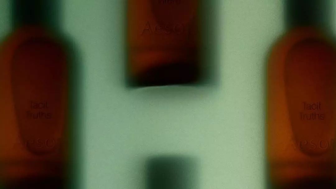 Blurred motion close-up of Aesop amber fragrance bottles with black caps against a pale background.