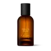 Amber glass Aesop Above Us, Steorra Eau de Parfum bottle with black cap on a white background.