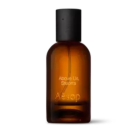 Amber glass Aesop Above Us, Steorra Eau de Parfum bottle with black cap on a white background.