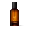 Amber glass Aesop Evoking Eidesis Eau de Parfum bottle with black cap on a white background.
