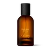 Amber glass Aesop Boundless Eremia Eau de Parfum bottle with black cap on a white background.