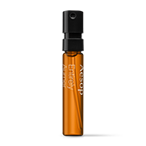 Product sample bottle with black cap on a light background.