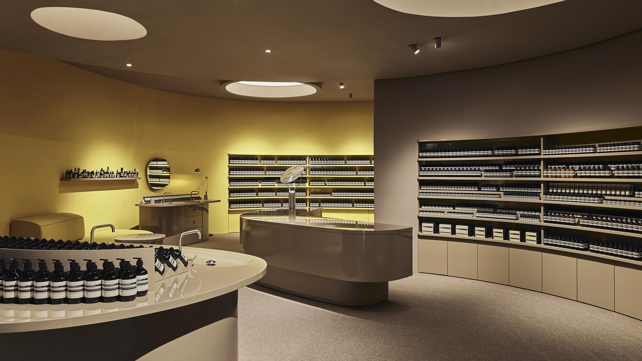 Aesop Miranda store interior. The shelves displaying the Aesop products behind the counter benchtop.