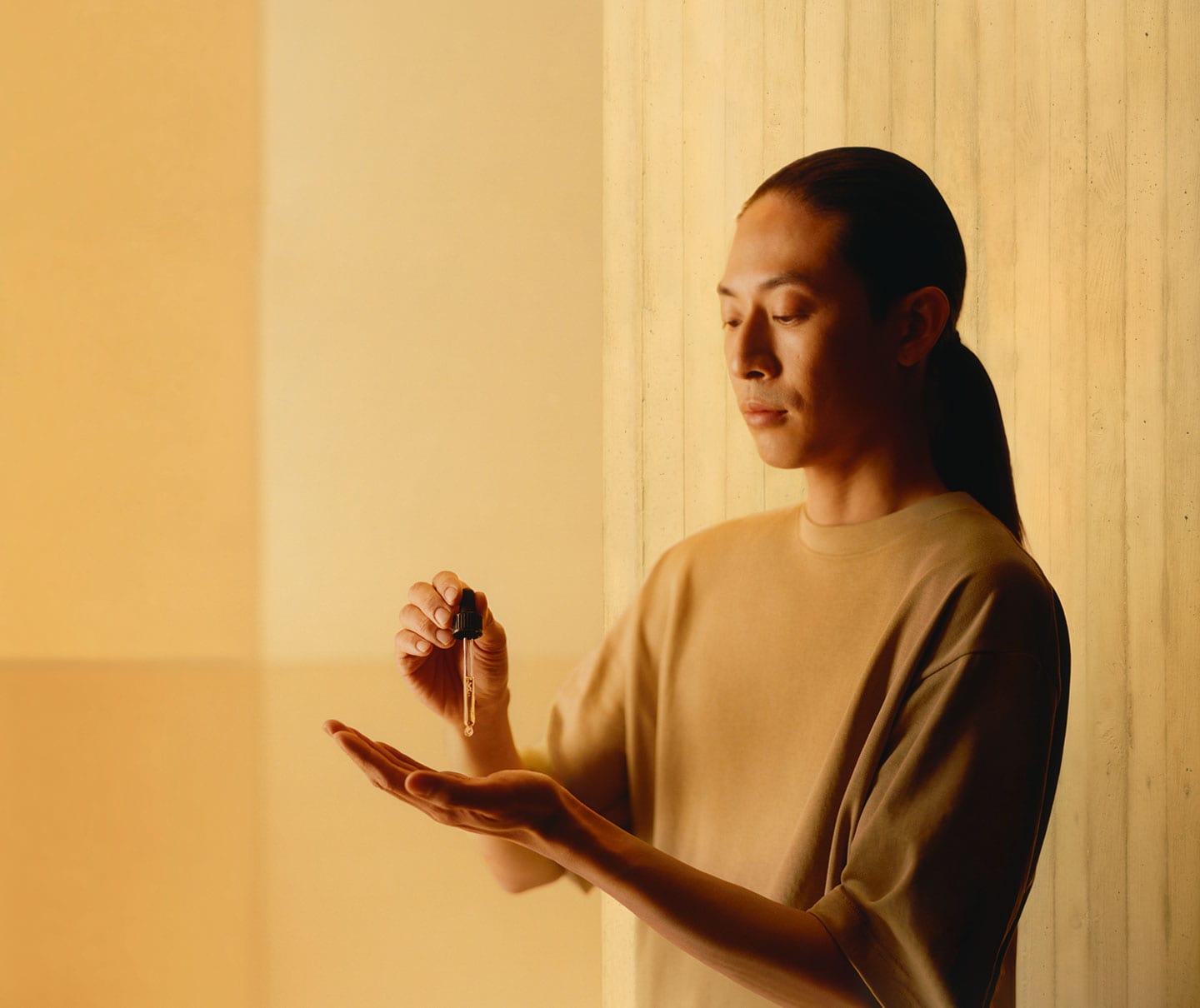 A person expelling serum from a pipette into the palm of their hand.