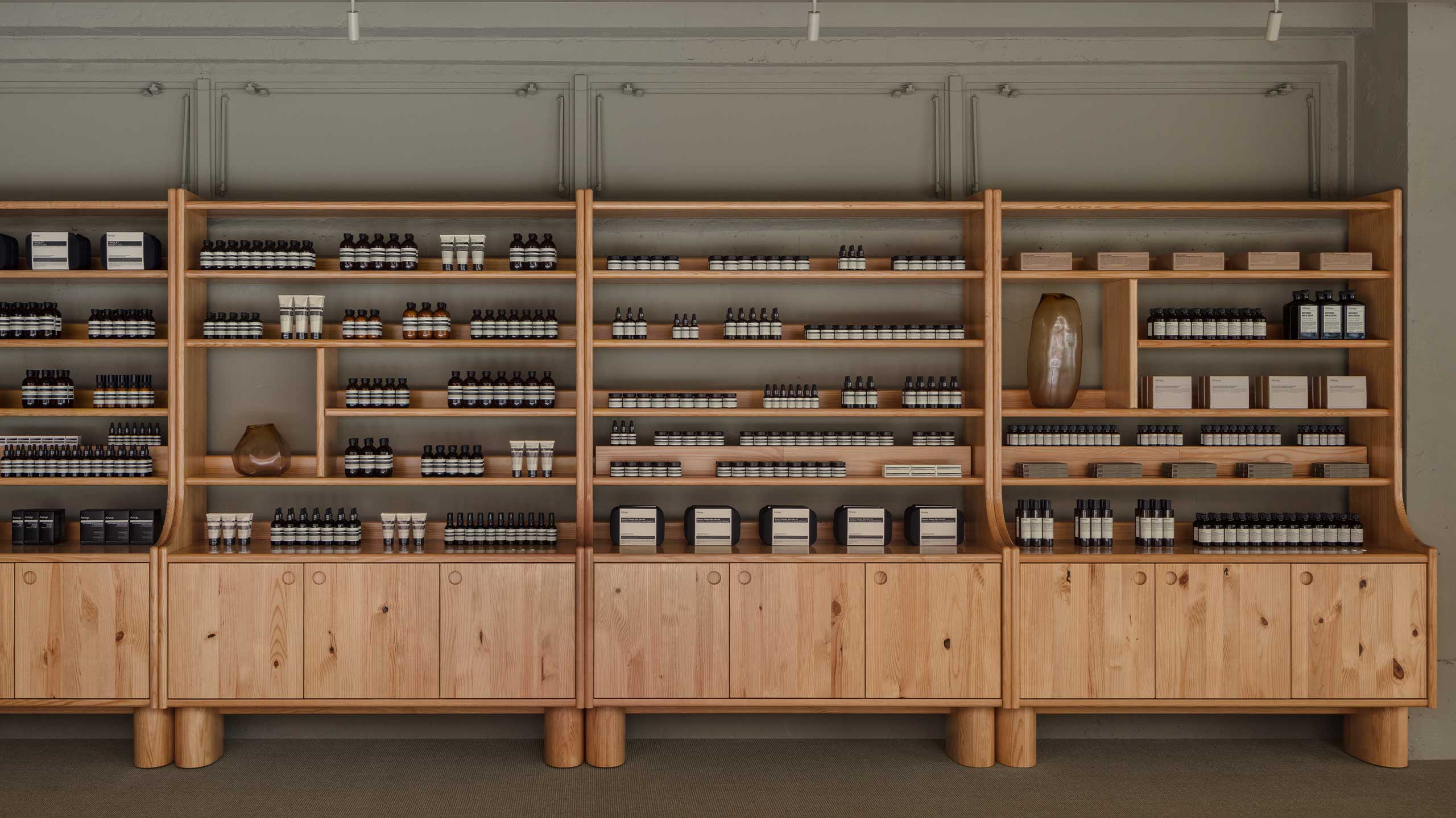 Aesop wide range of products on the pine wood shelves