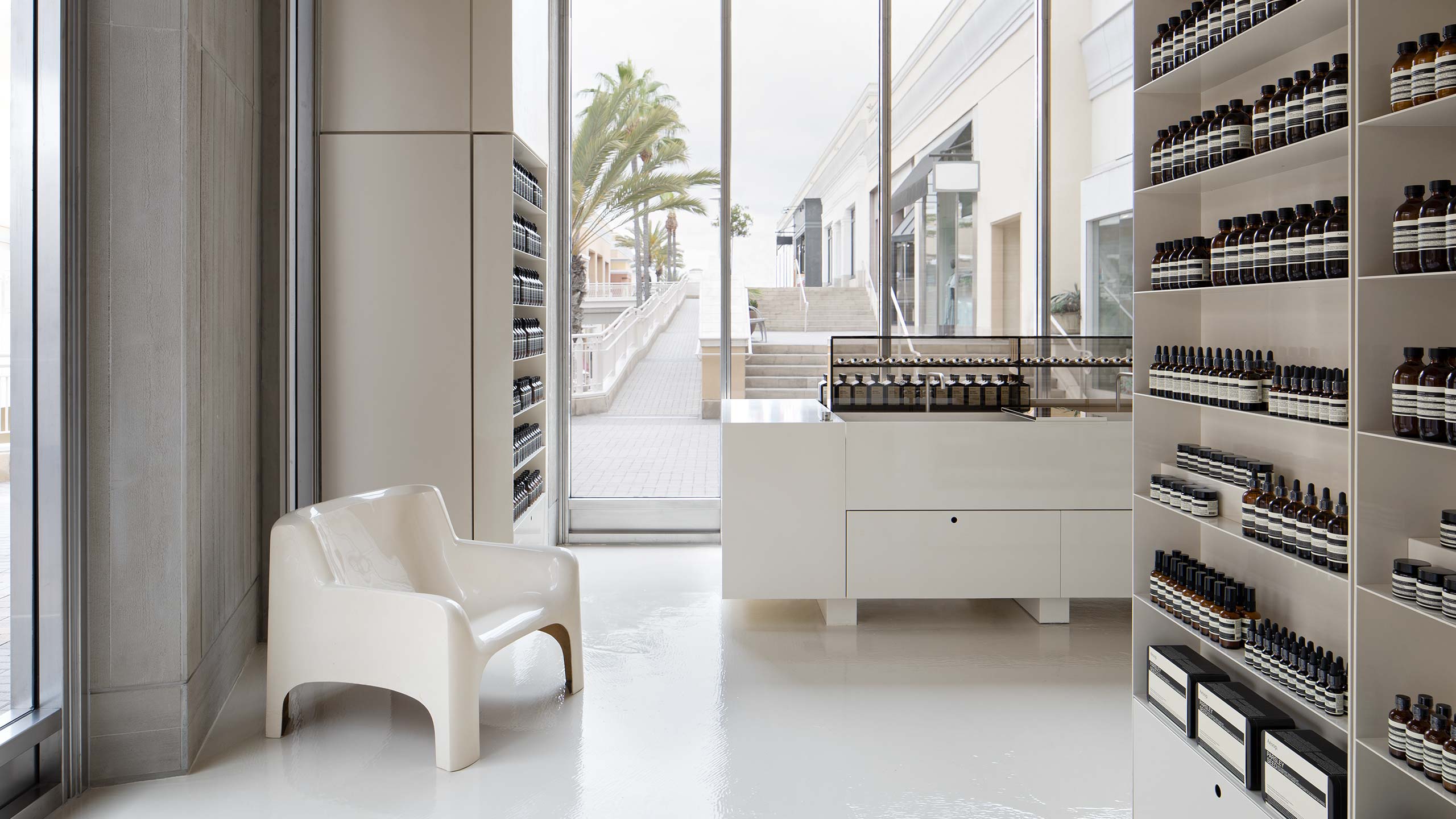 Store interior featuring designer chair and minimalist style architecture.
