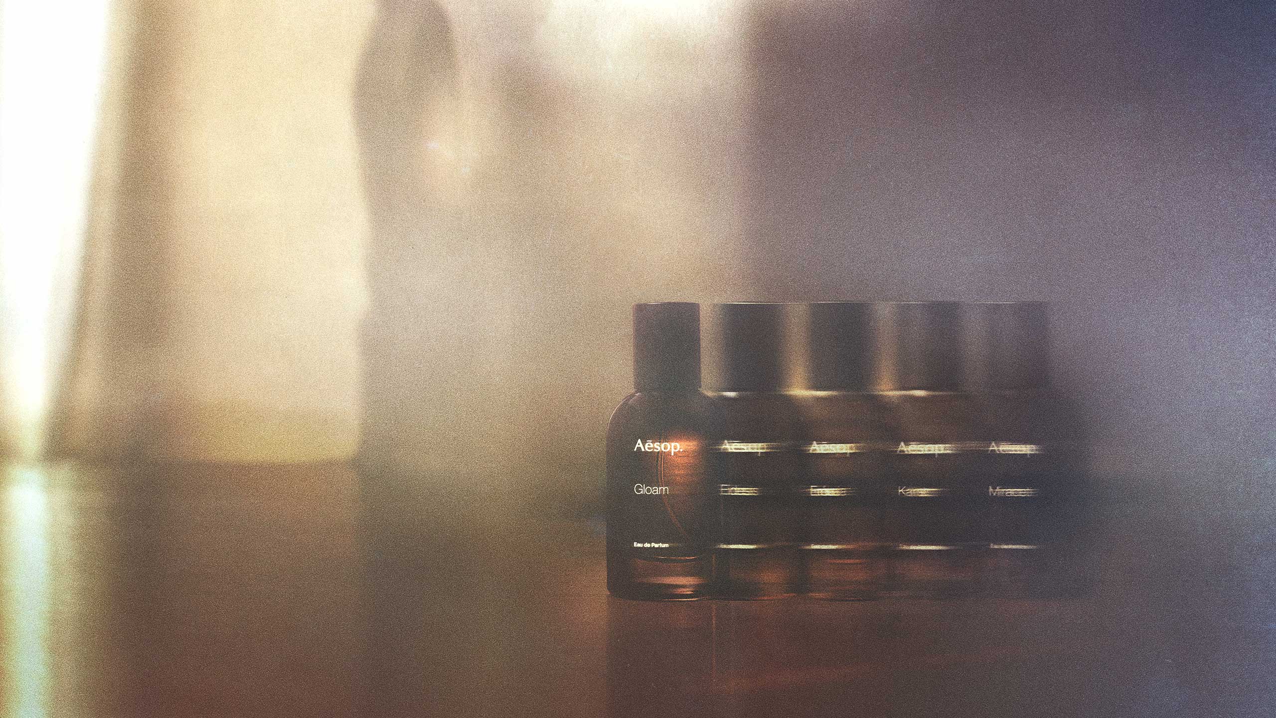 Line-up of glass amber bottles in the Othertopias fragrance range.