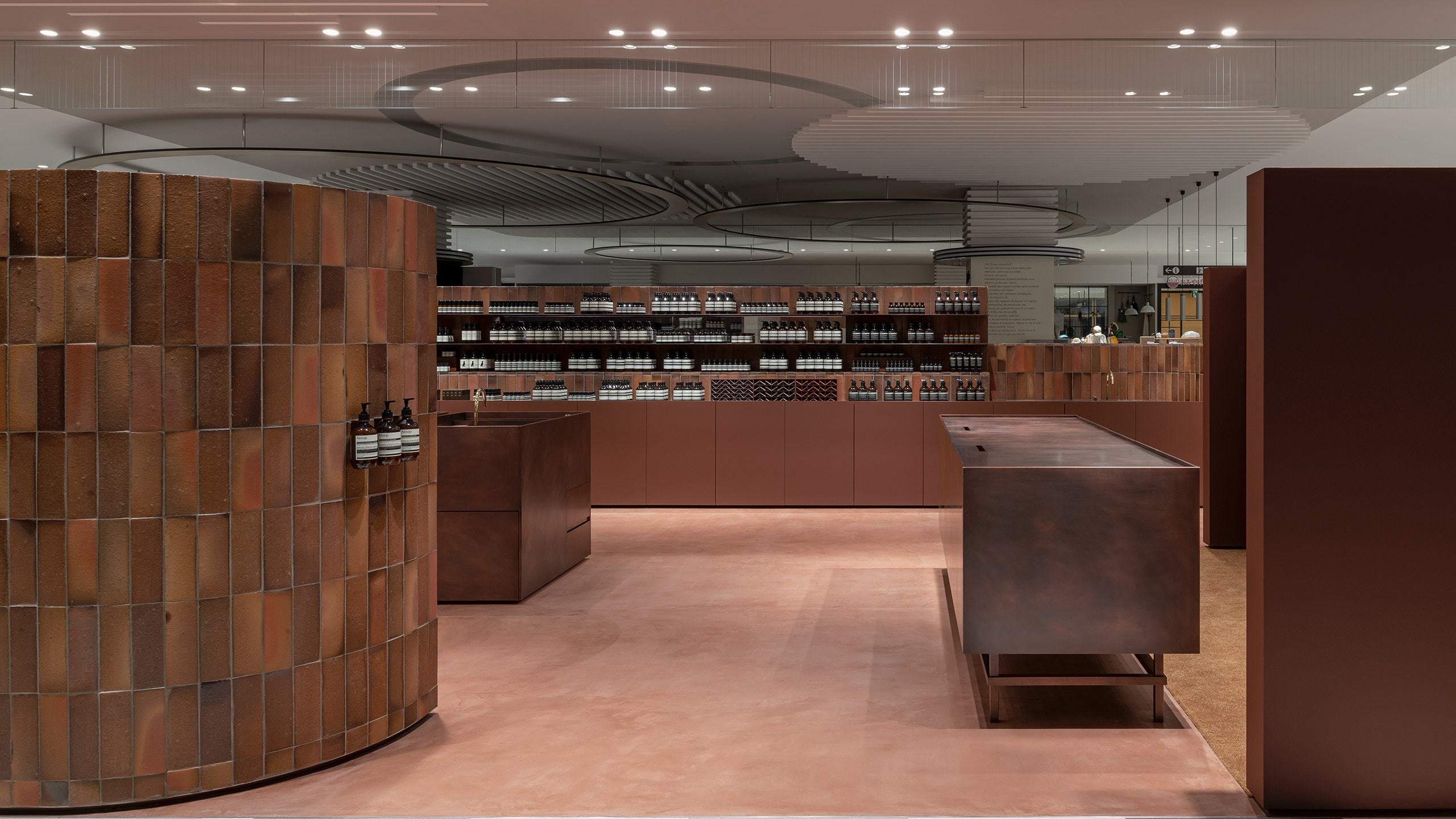 The clay clads the walls and shelves of the store in its rich red-brown colour