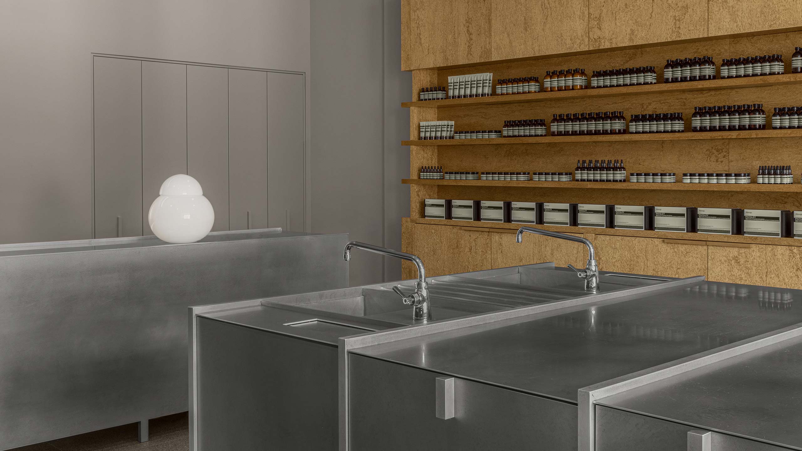 Aesop Yorkdale store interior, featuring metallic basins and counter