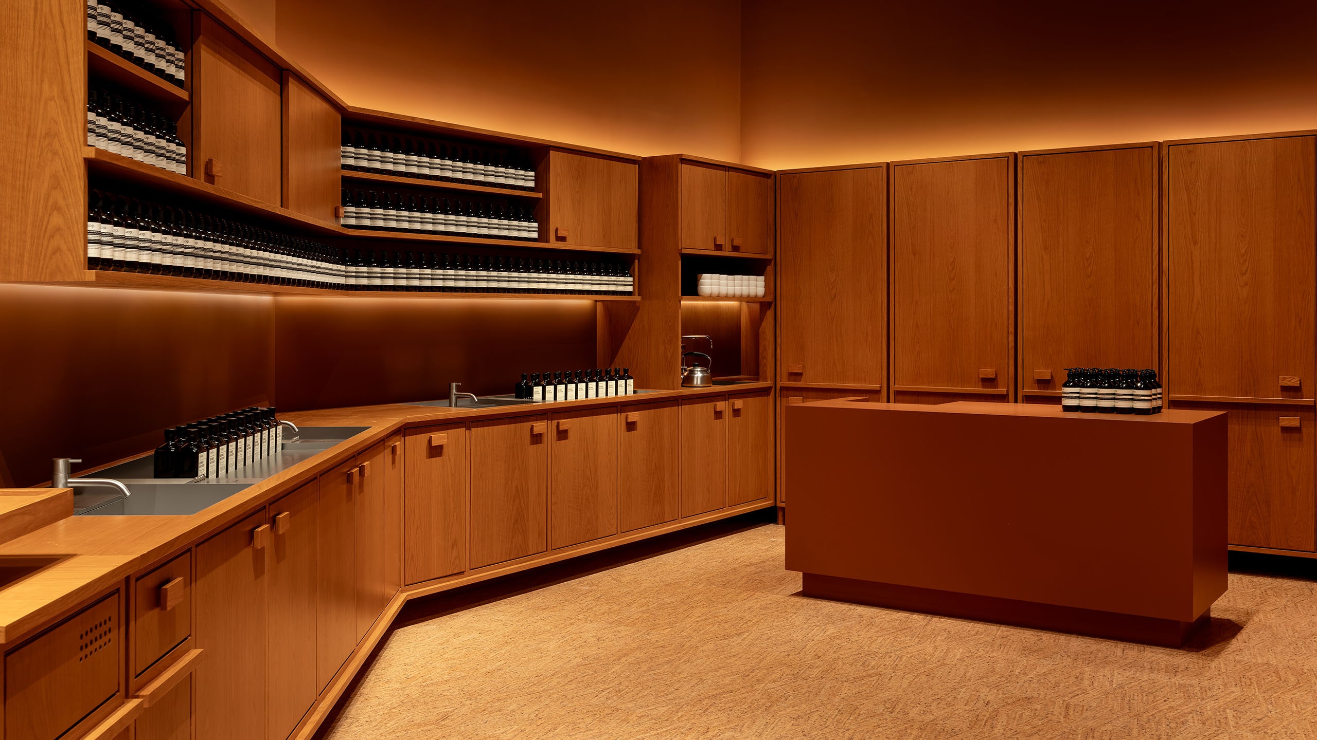 Wooden cabinet with Aesop products on the shelves 