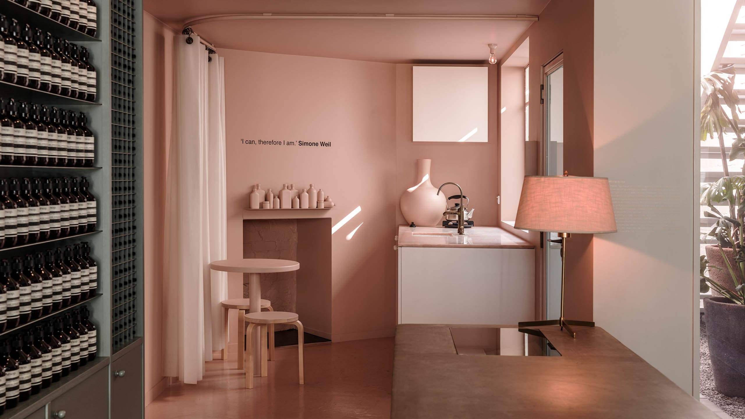 A blush-pink kitchenette that sits at the back of the store. Features an inbuilt sink with brass fixtures. 