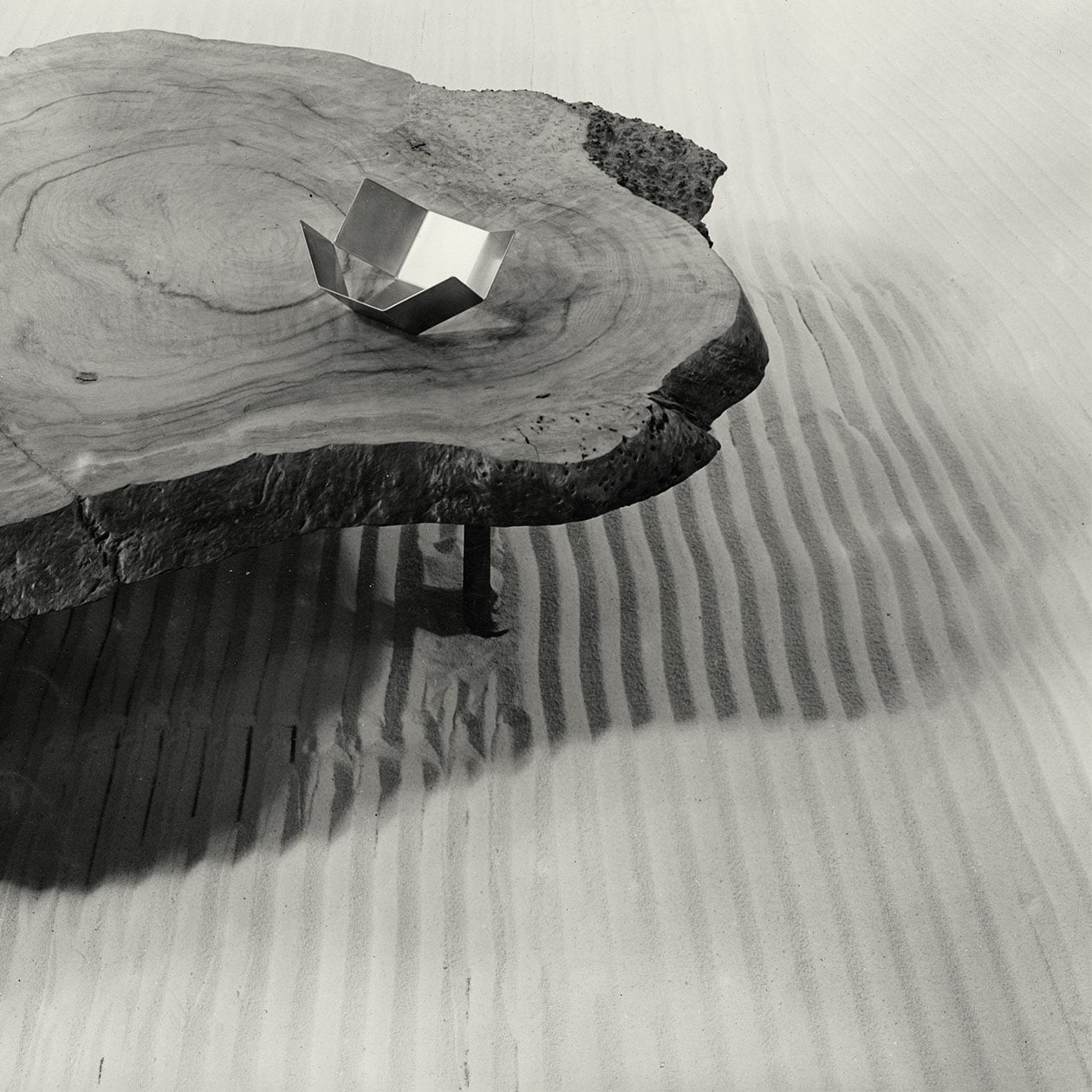A table made by Charlotte Perriand on top of sand.