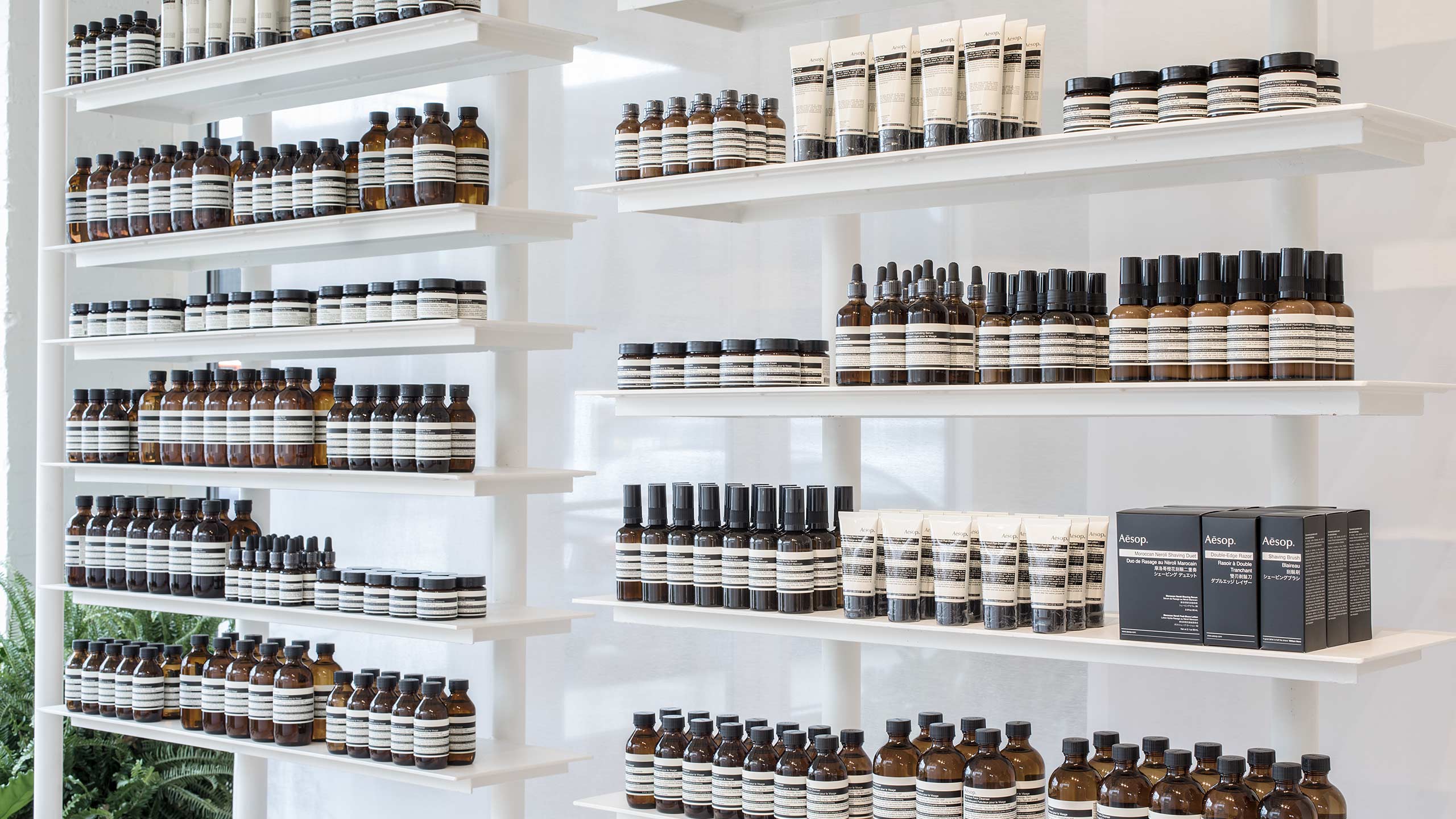 A close-up shot of the floating white product cabinetry in Aesop Montrose