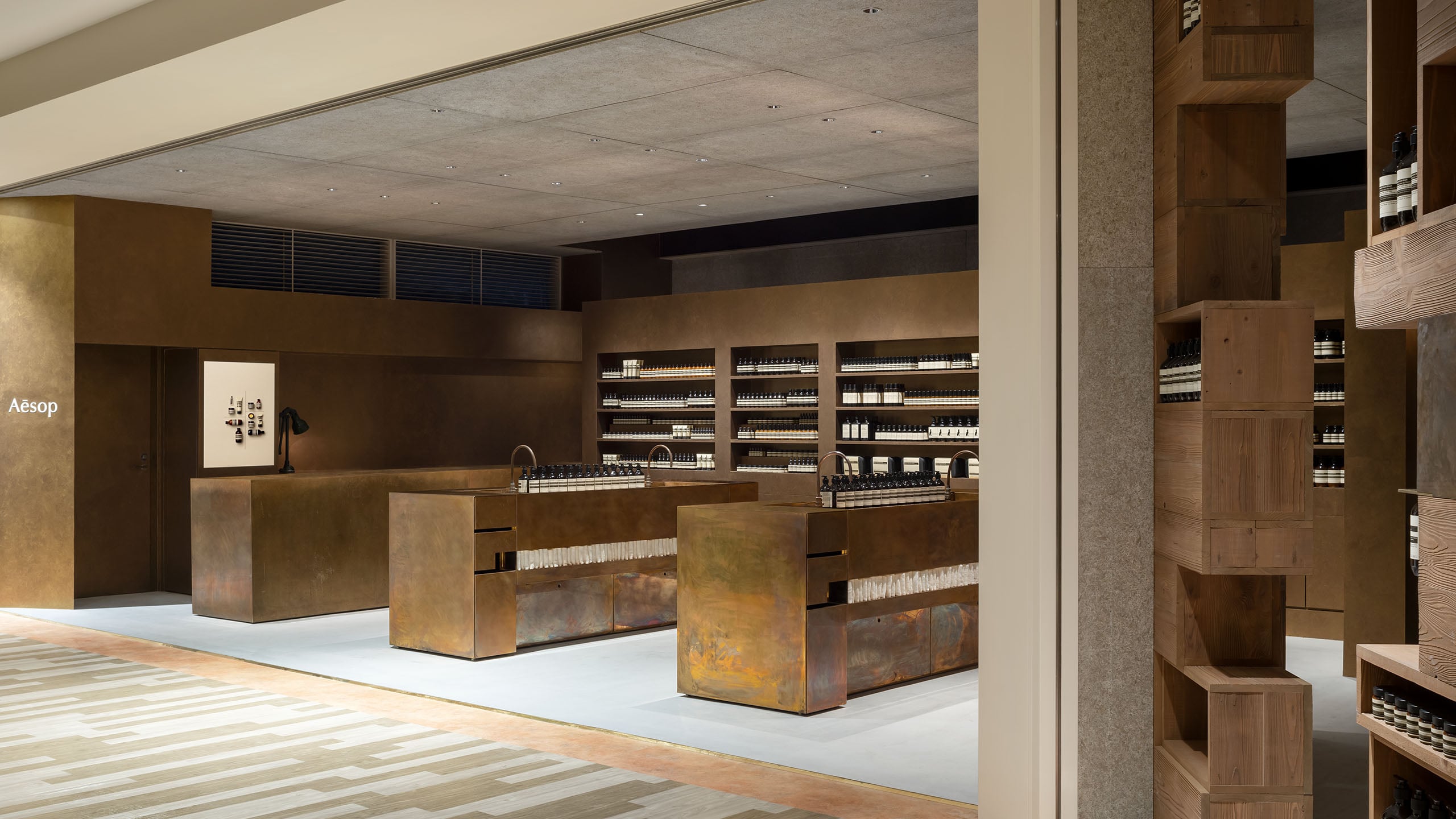 Aesop Amu plaza Hakata store overview, gold-coloured atmosphere with several basins