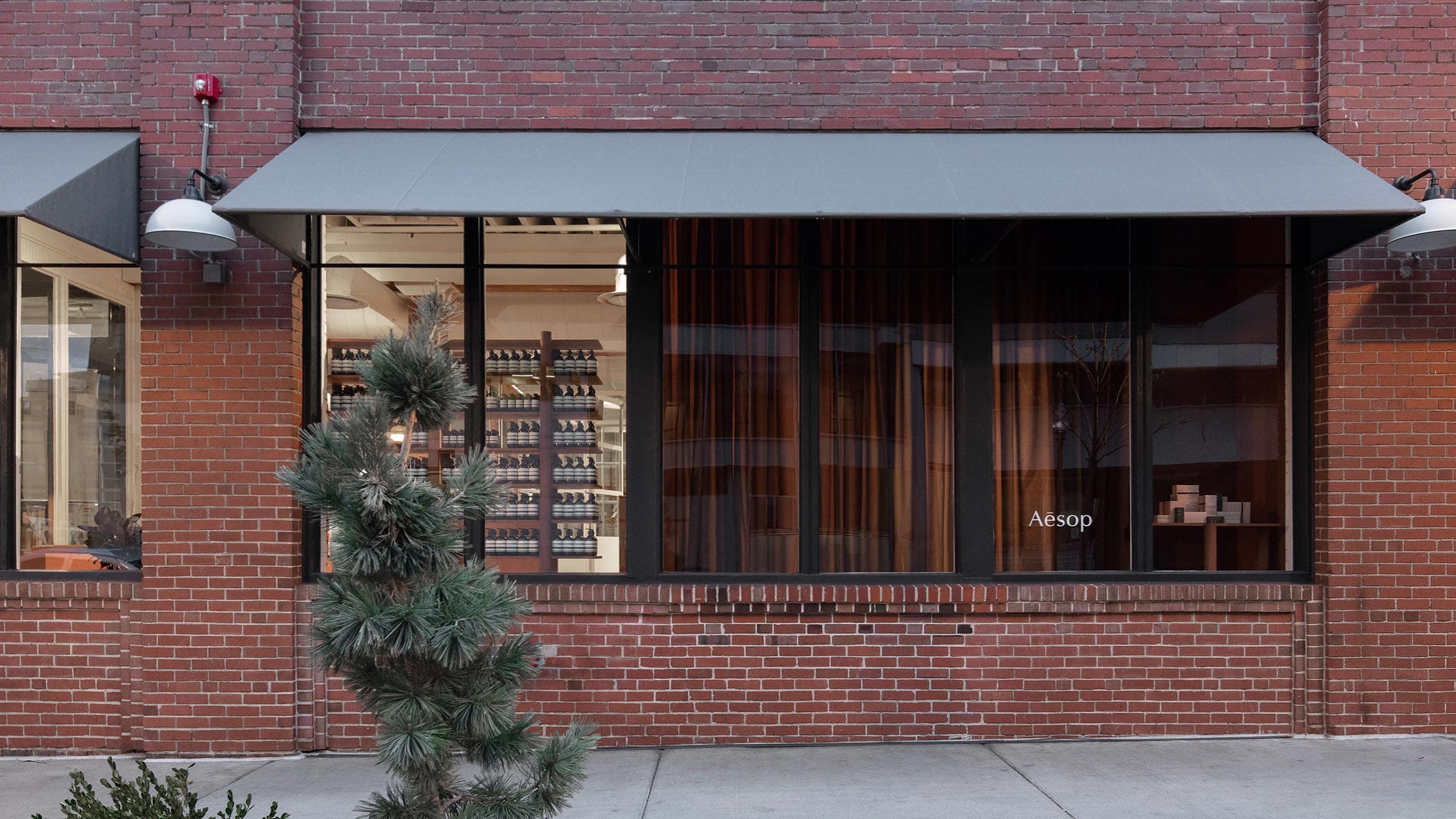 A street view of Aesop Free Market brick store exterior