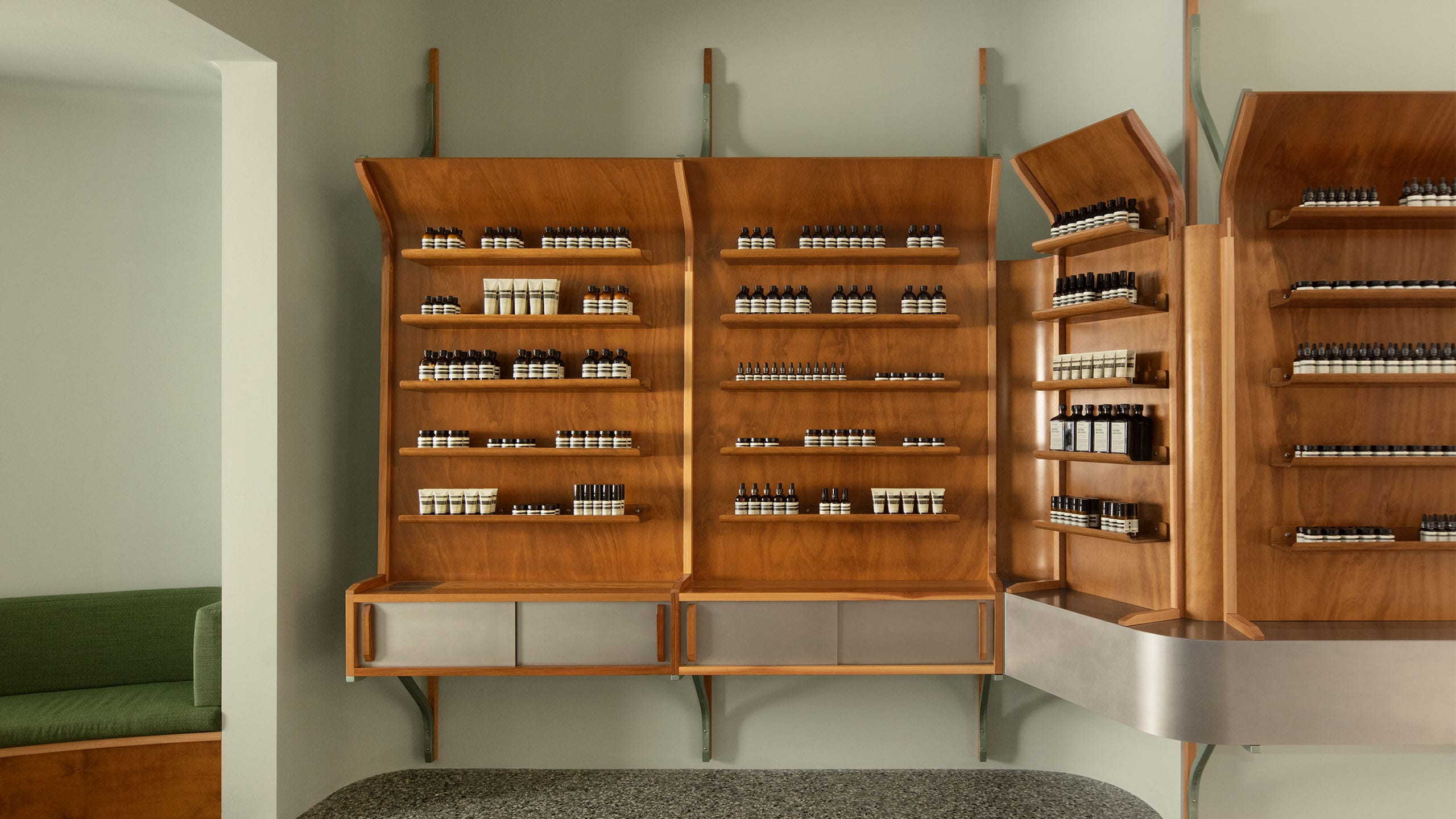 Aesop products placed on lacquered wood shelves
