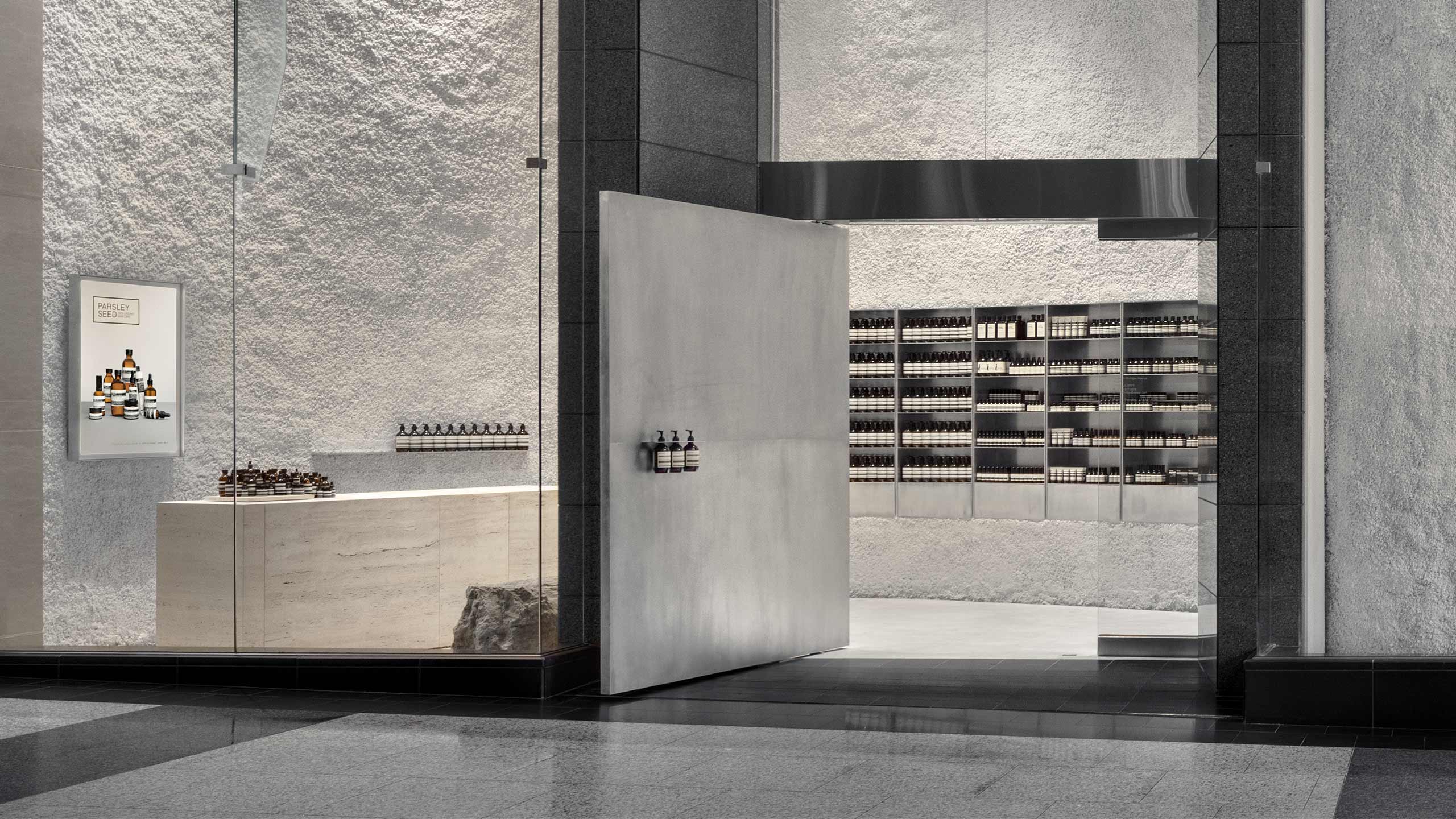 Store entrance featuring white and steel materials on the exterior