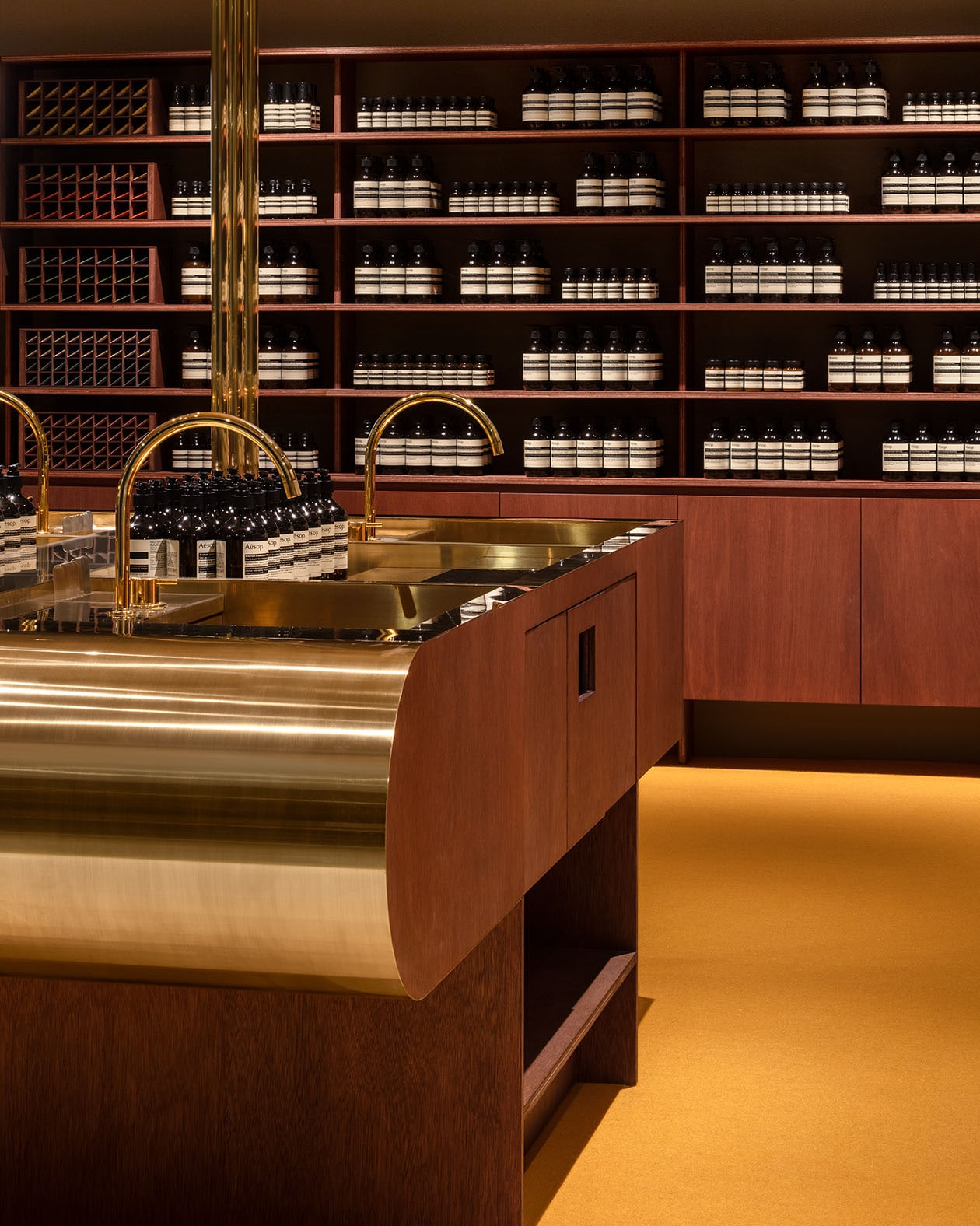 A communal basin, fixtures and countertops in brass metal