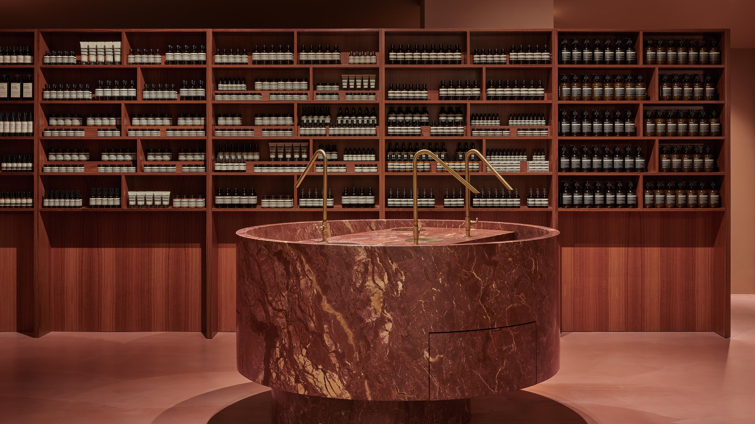 The centrepiece of the store is the red velvet marble basin with elegant brass fixtures. 