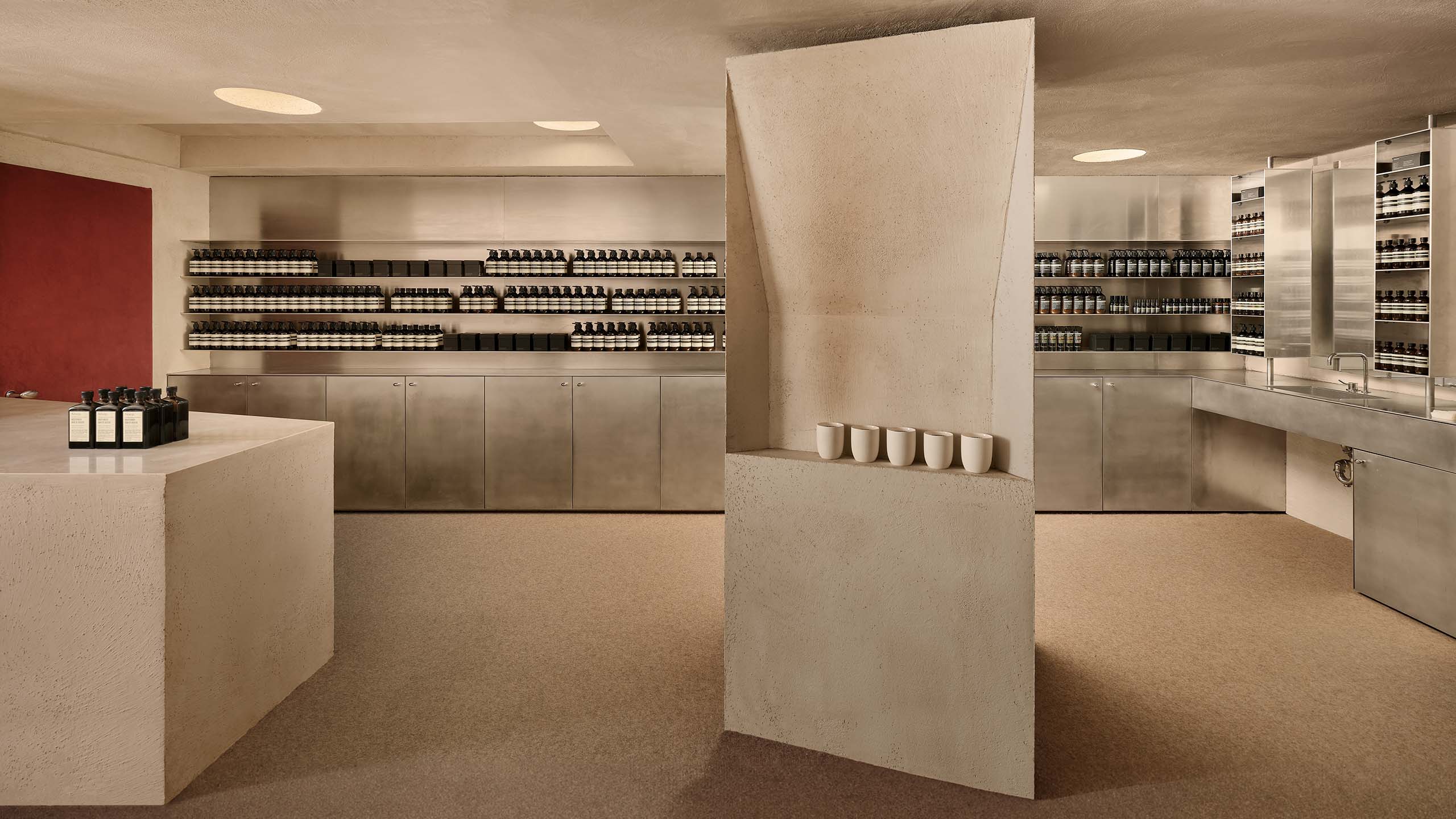 store interior with cement column in foreground with and red door in left background