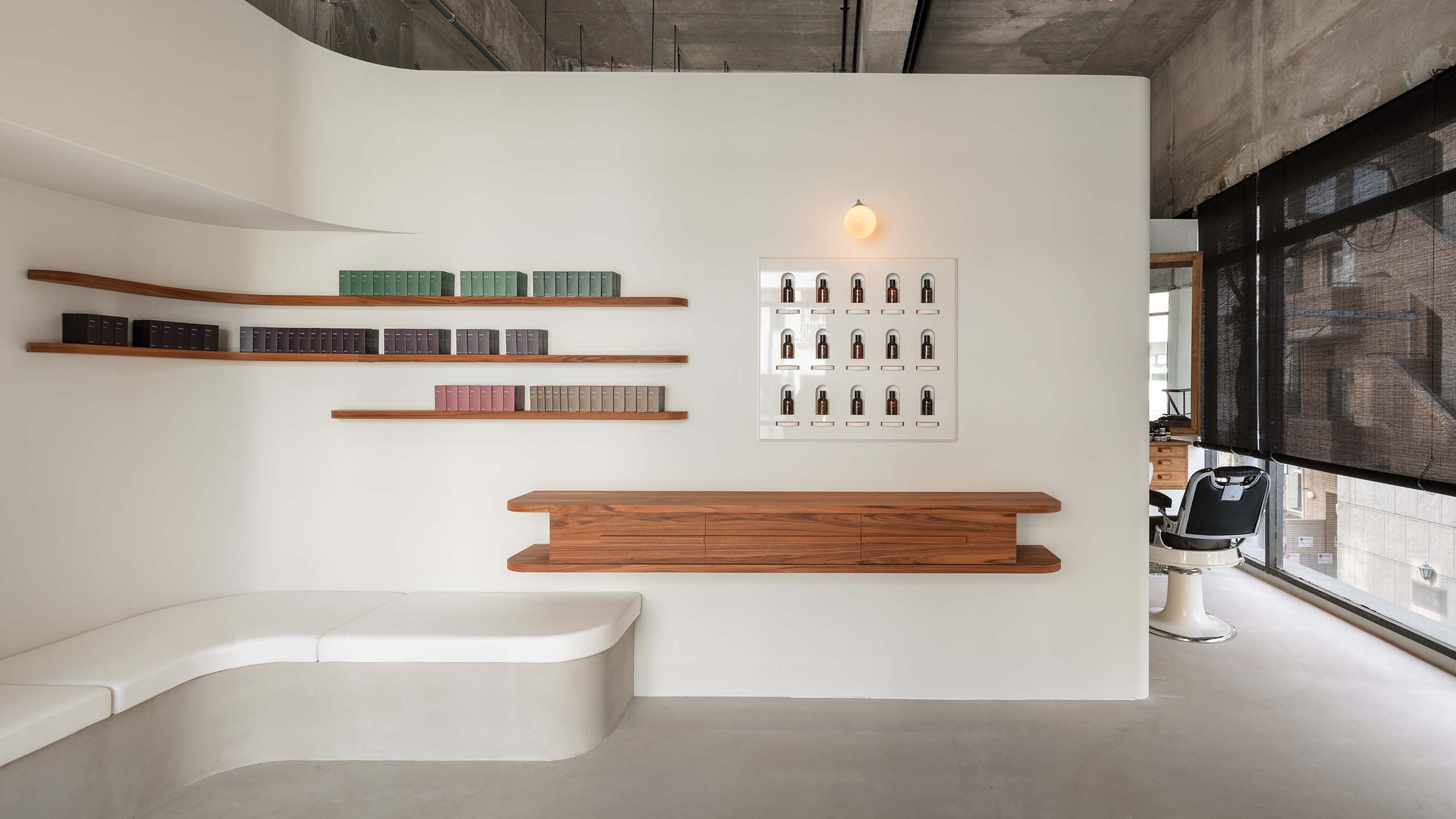 A bench and timber furnishings next to Aesop’s fragrance range