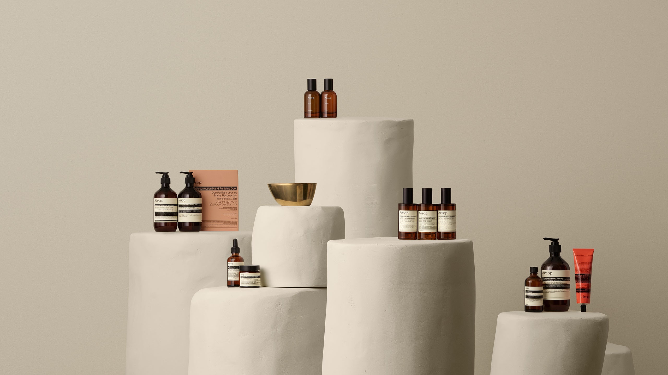 Aesop products placed on a white stone pillars