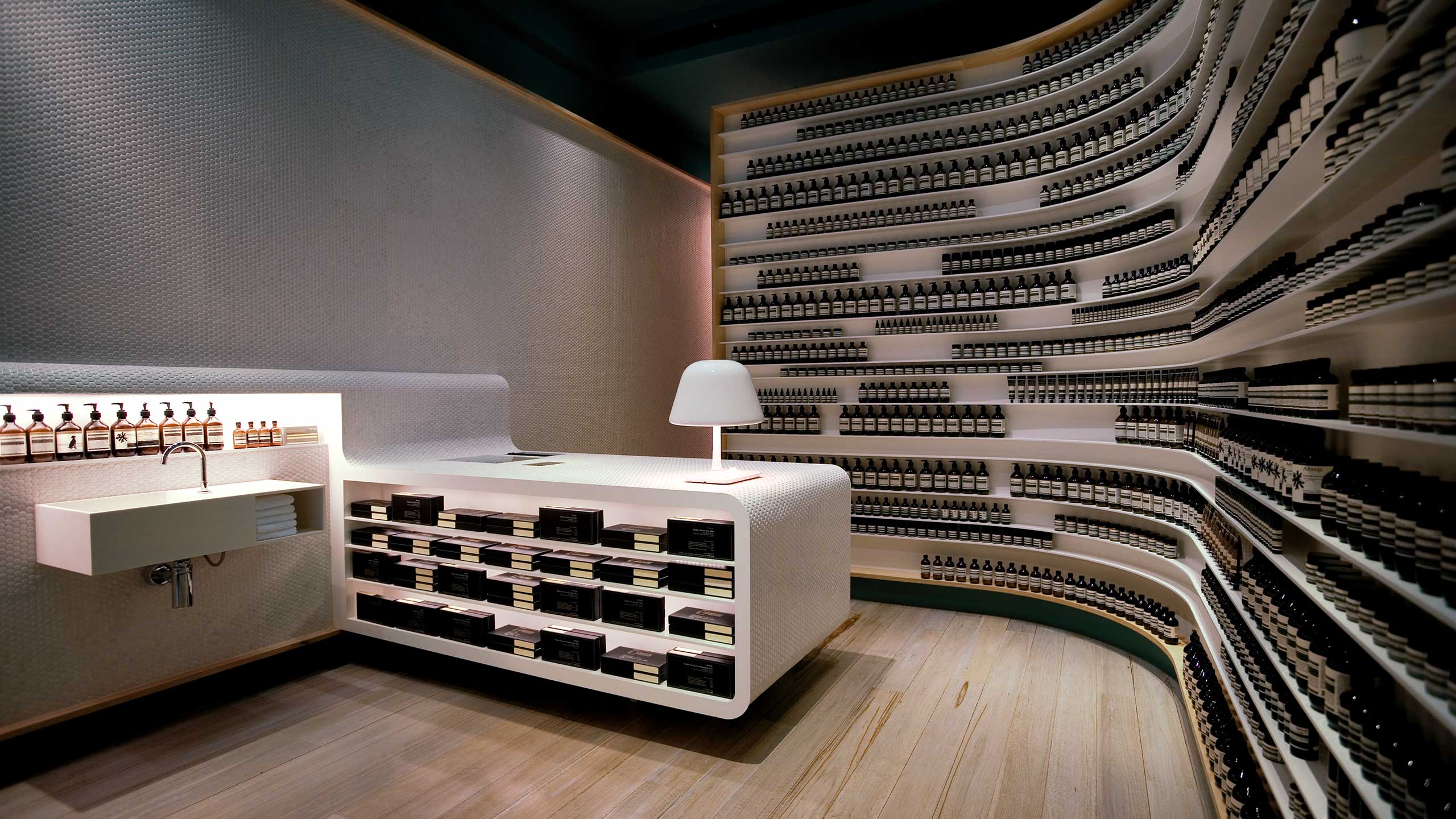 Alternative angle of the white store counter showing a basin attached to the wall. 