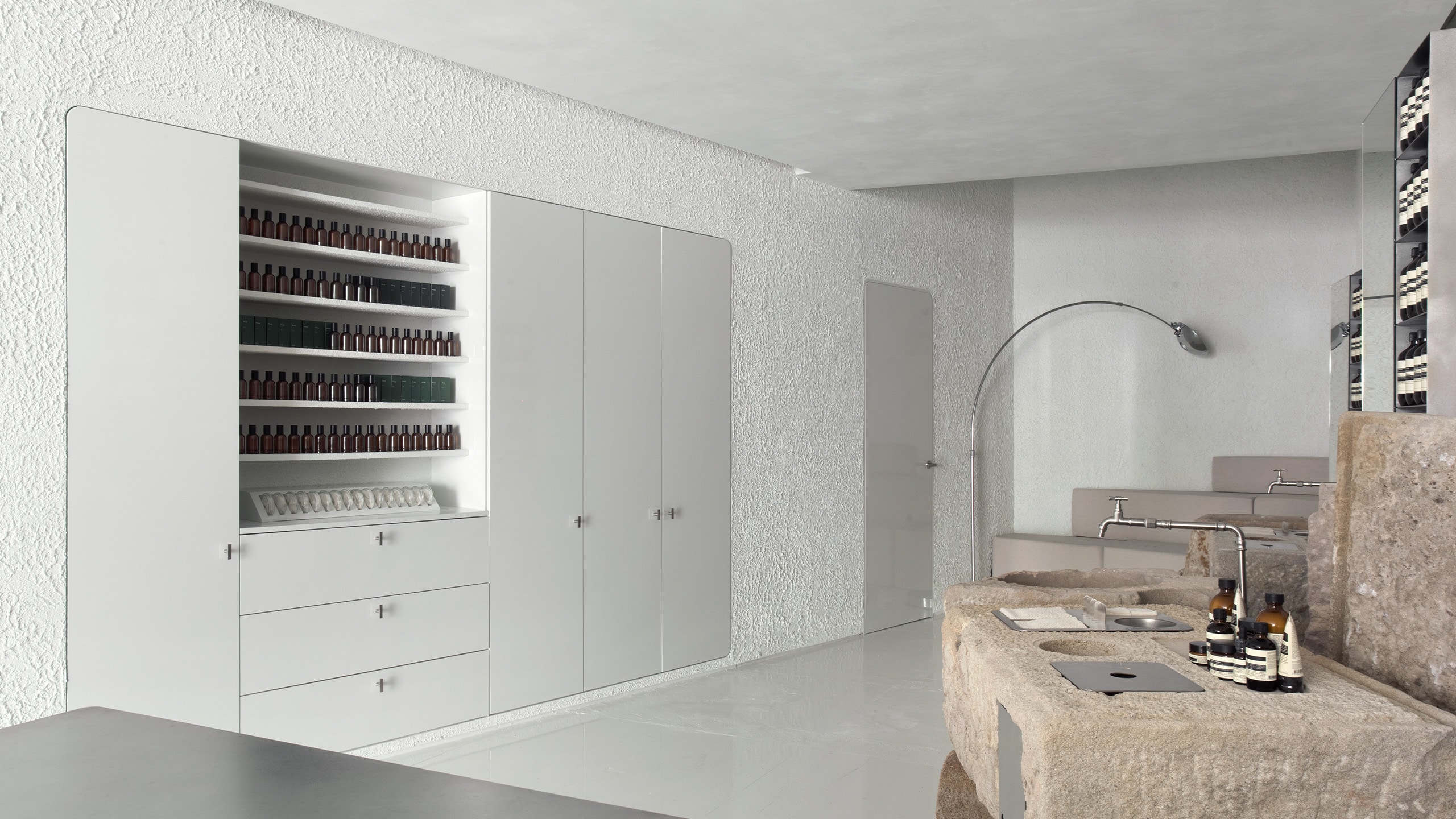 Aesop Diagonal store basin, concealed shelving and fragrance product display.