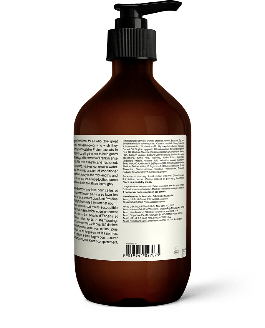 Back of Conditioner in a large, dark-brown bottle with a black pump.