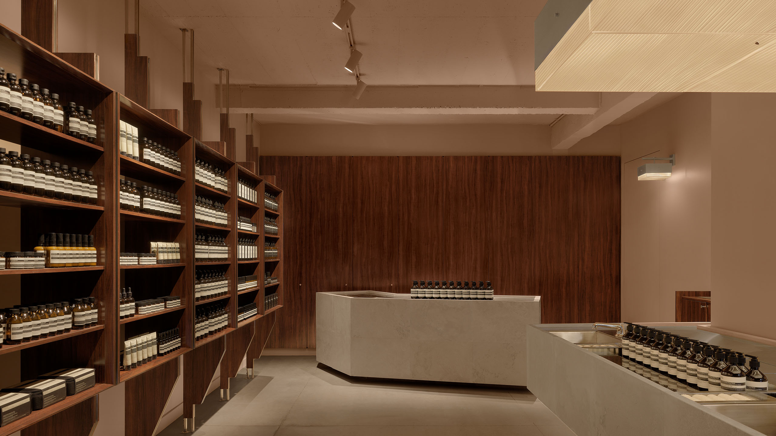 store interior featuring large granite basin, granite checkout counter, product on wooden shelves, and wooden back wall