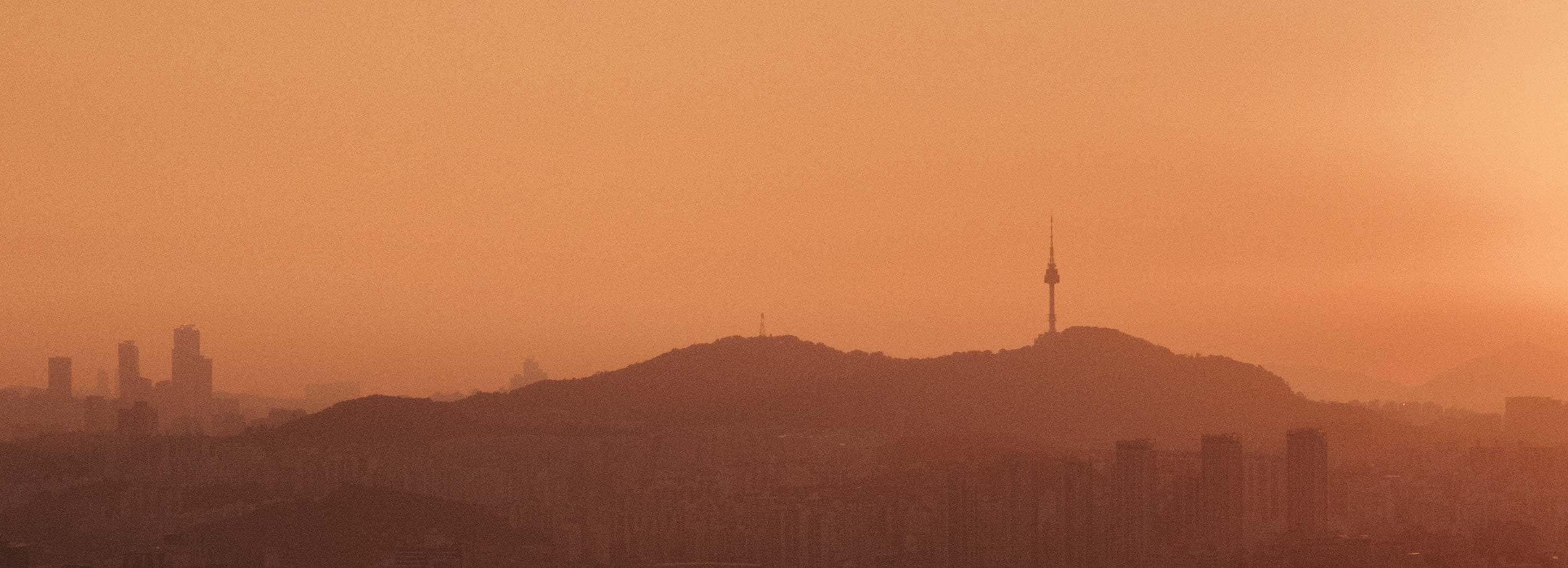 The sun setting on a Seoul skyline.