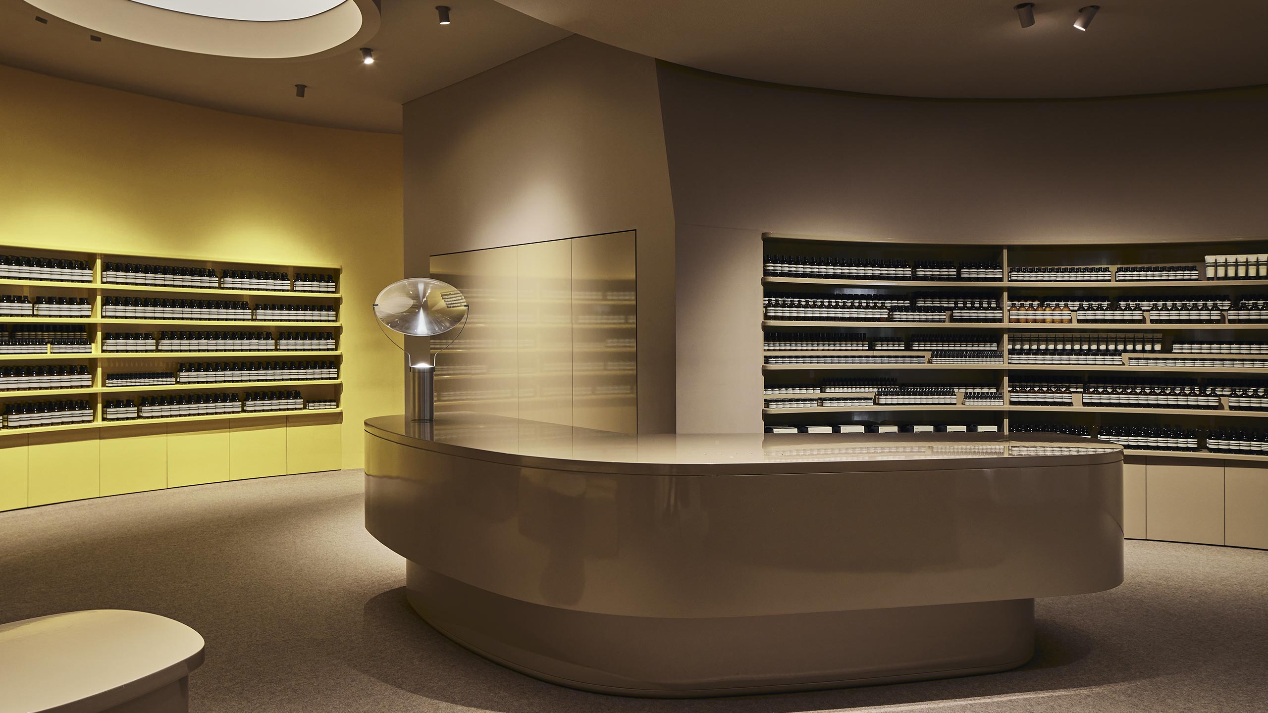 Aesop Miranda store interior. The shelves displaying the Aesop products behind the counter benchtop 
