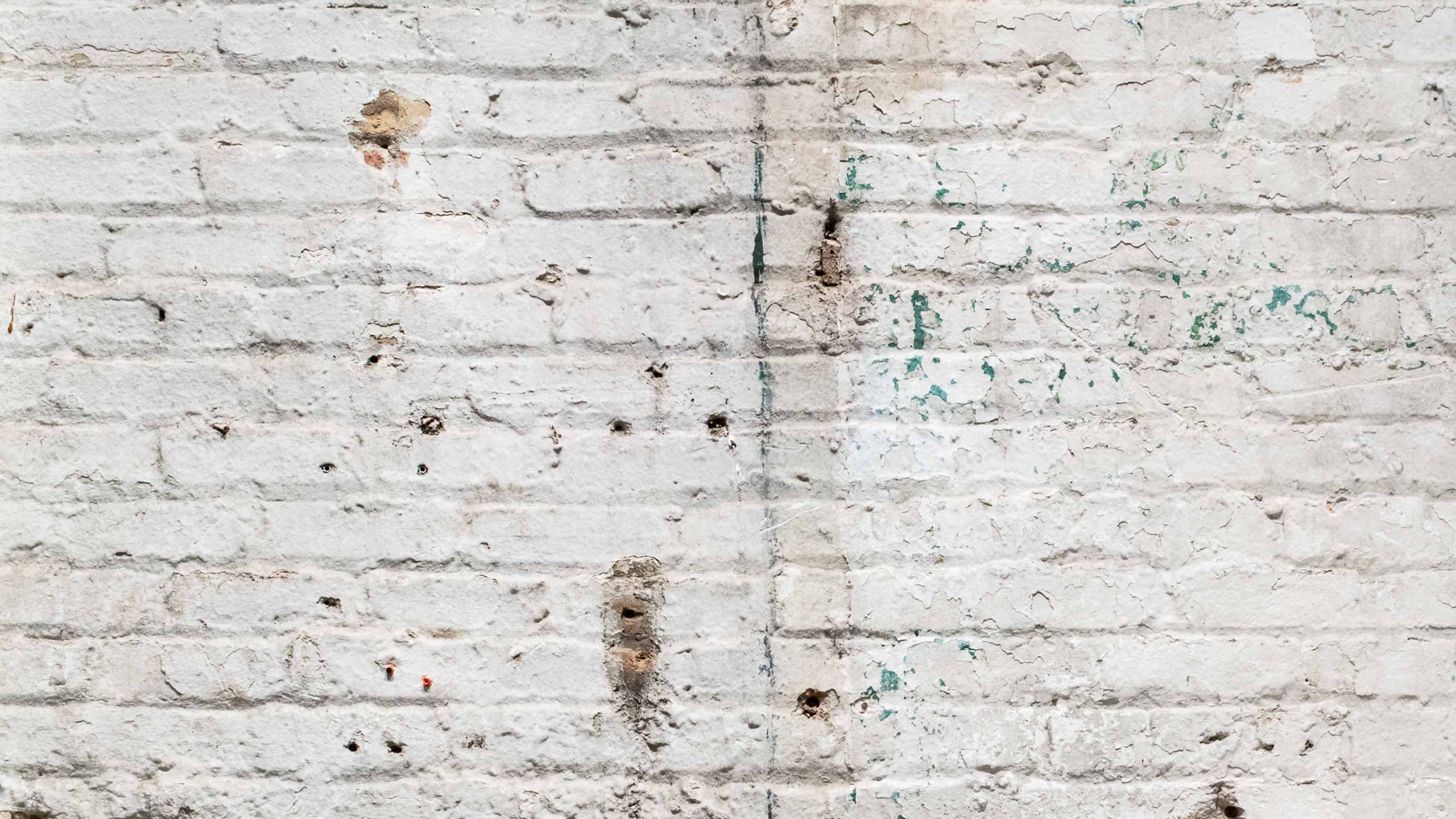 A photograph of a dry brick wall representing dry skin.