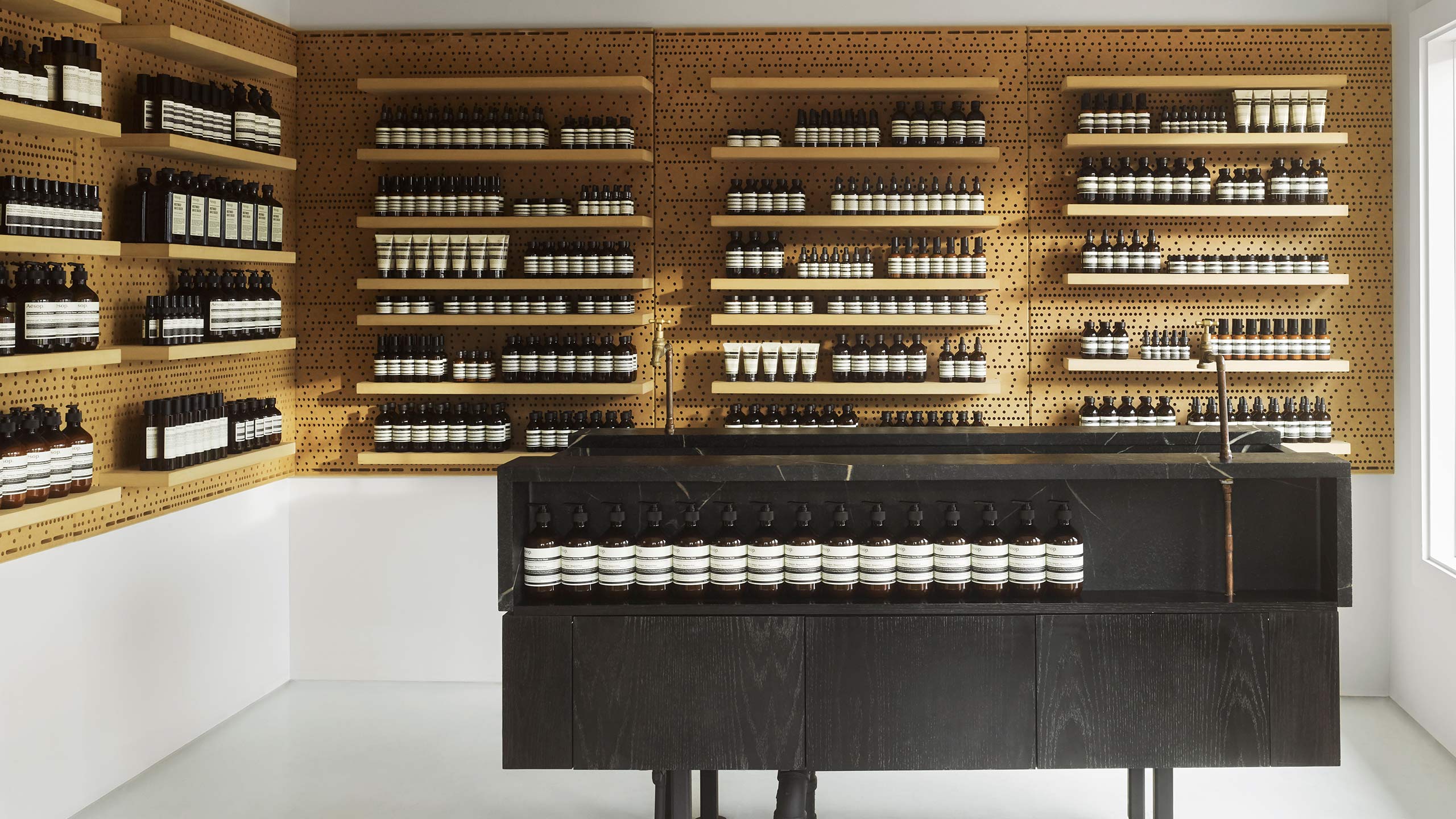 The basin at Aesop Lido Marina, with honeycomb style pegboard wall and cabinetry in the background.