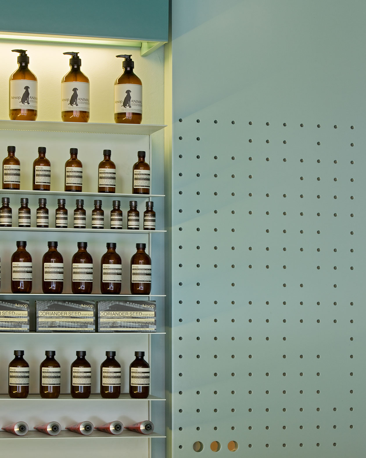 A close up of one of the product display shelves alongside the perforated wall.