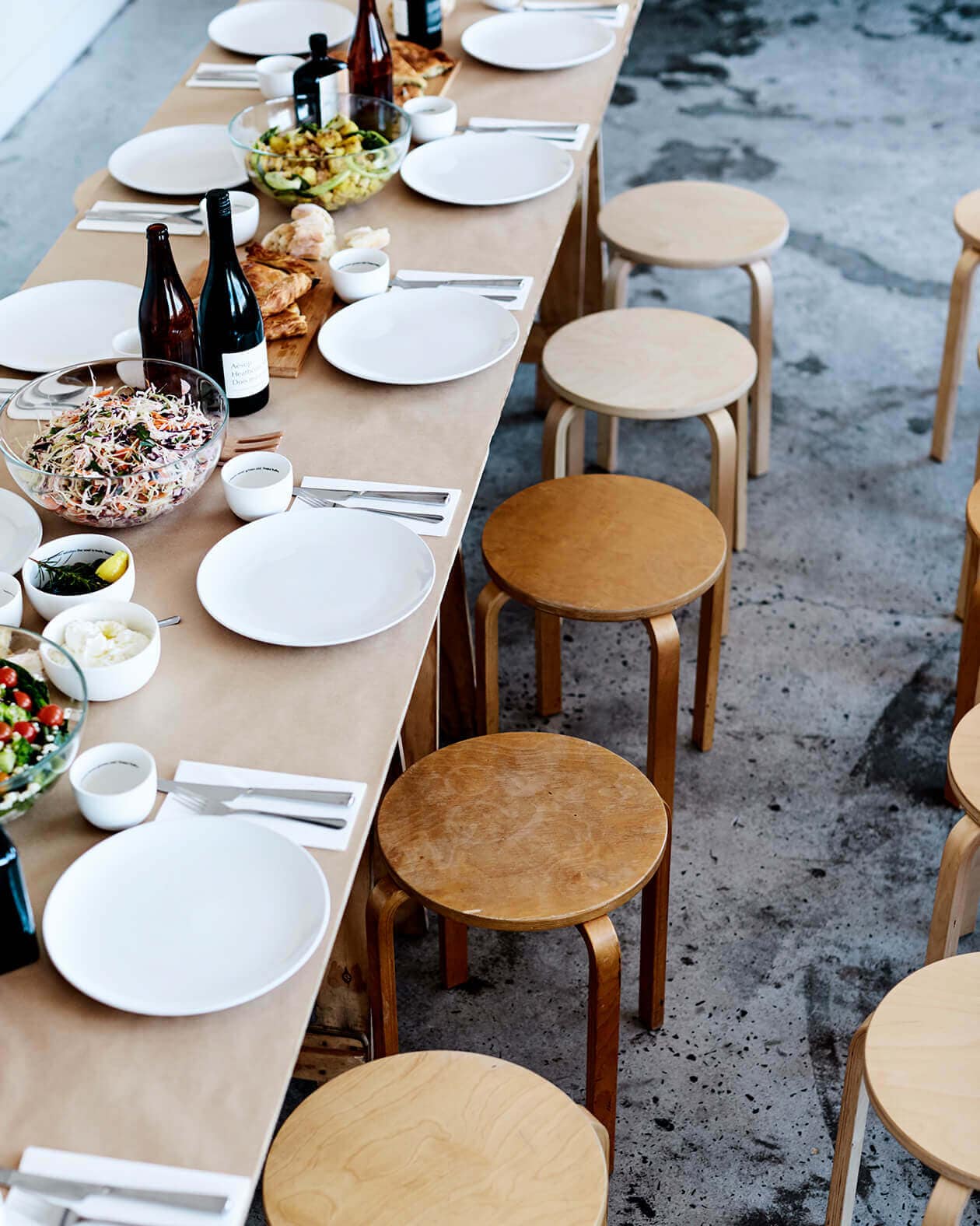 Large table set for a meal at Aesop's head office.