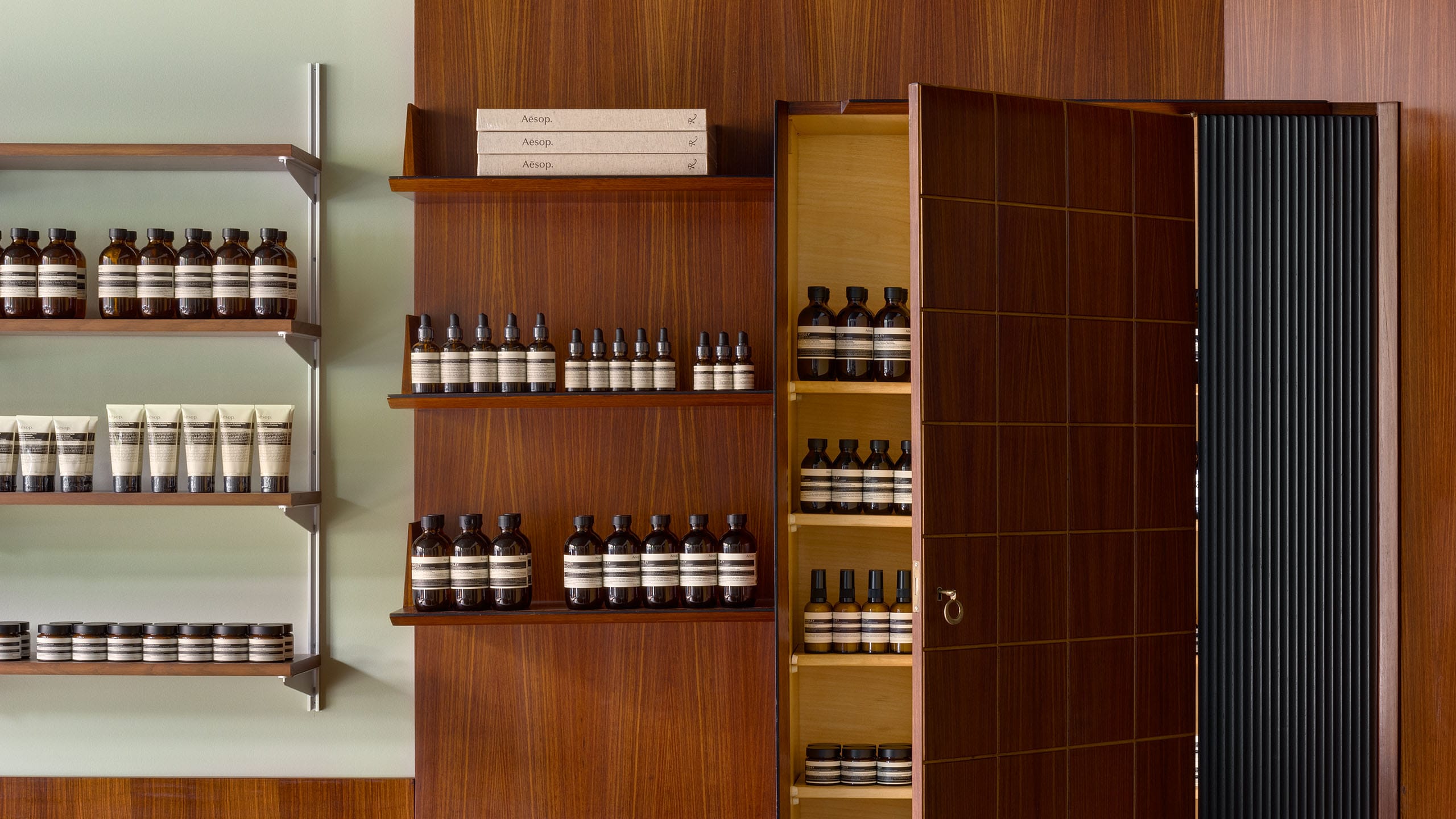 Aesop Madison Avenue store interior featuring wood panel wall with product on shelves