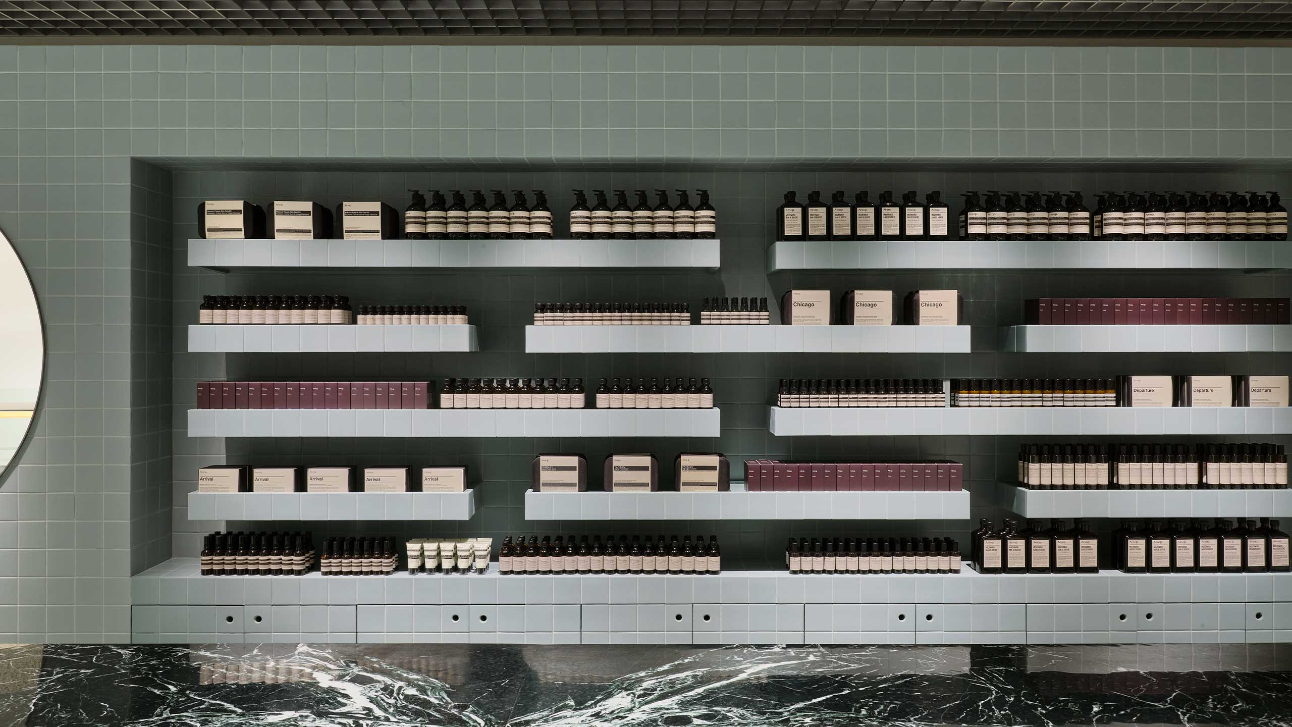 Aesop products showcasing on the ceramic-tiled walls.