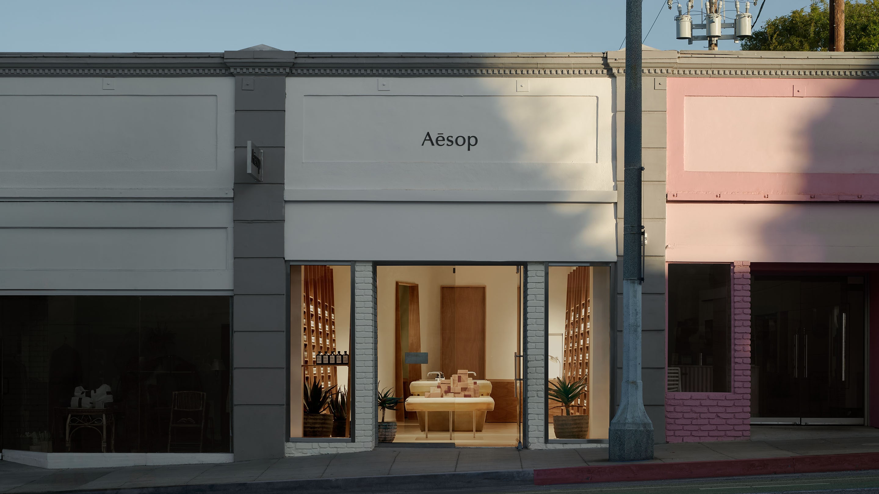 storefront image featuring concrete building facade and glass door and windows