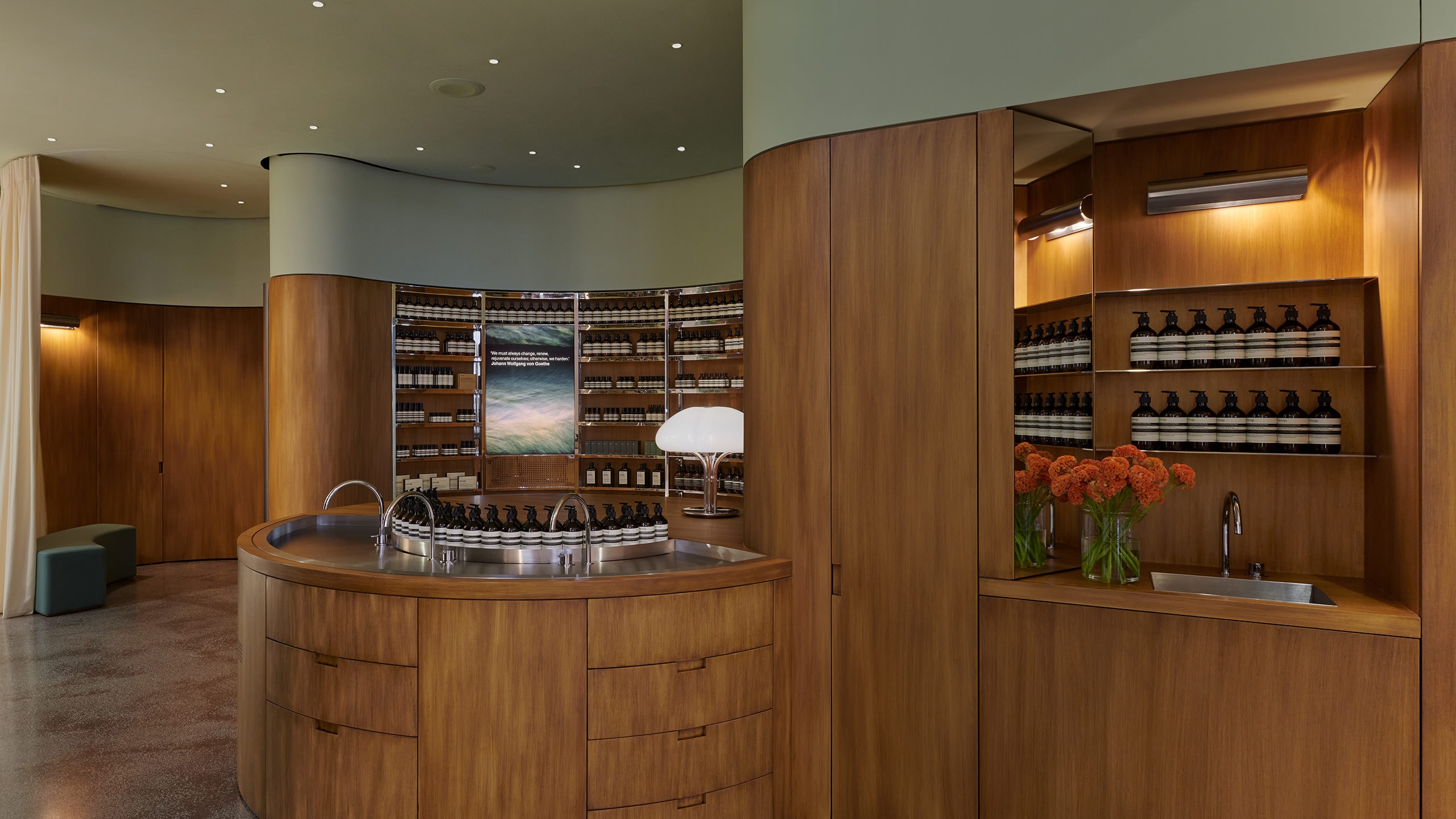 Aesop Hysan Place store view with a sweeping central basin and the open steel shelves