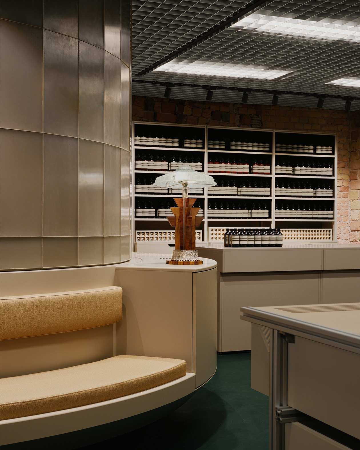 Aesop Kurfurstendamm store interior bench seat and Aesop product amber bottle display in the background