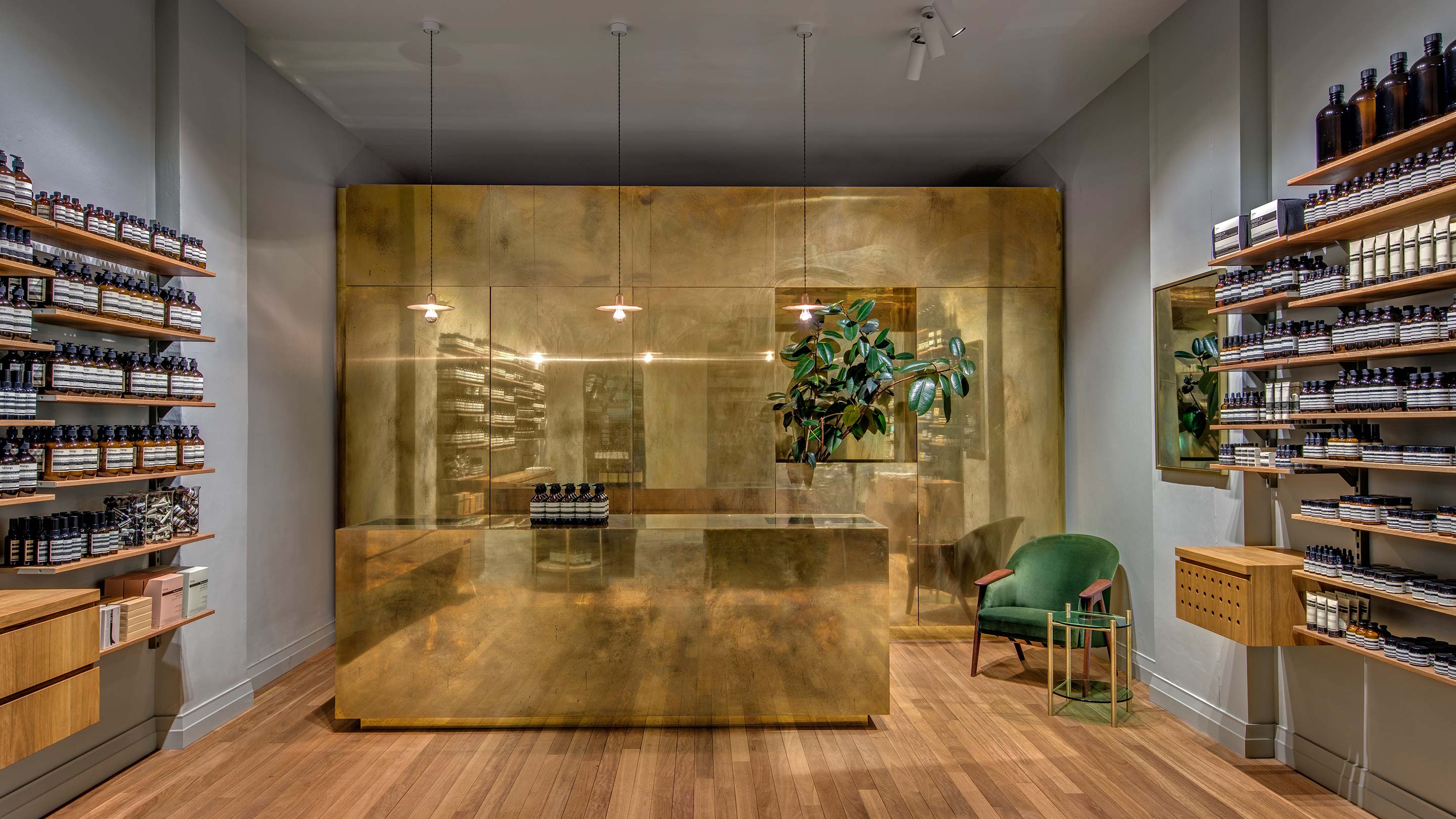 A store interior constructed with a Tallowood floorboards and a brass dividing wall and customer point-of-sale.