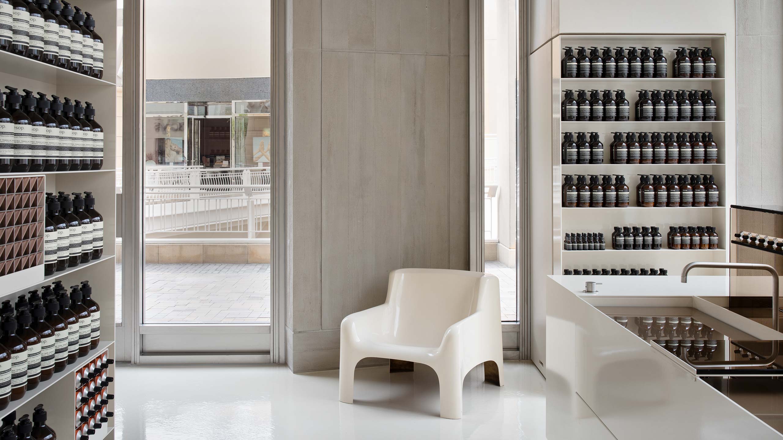Concrete wall featuring space-age mid-century chair.