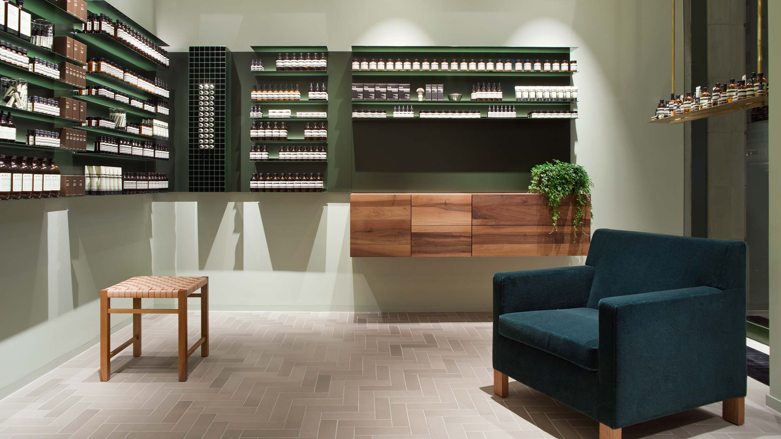 Aesop Kaiserplatz interior with a blue chair and product displayed on shelving