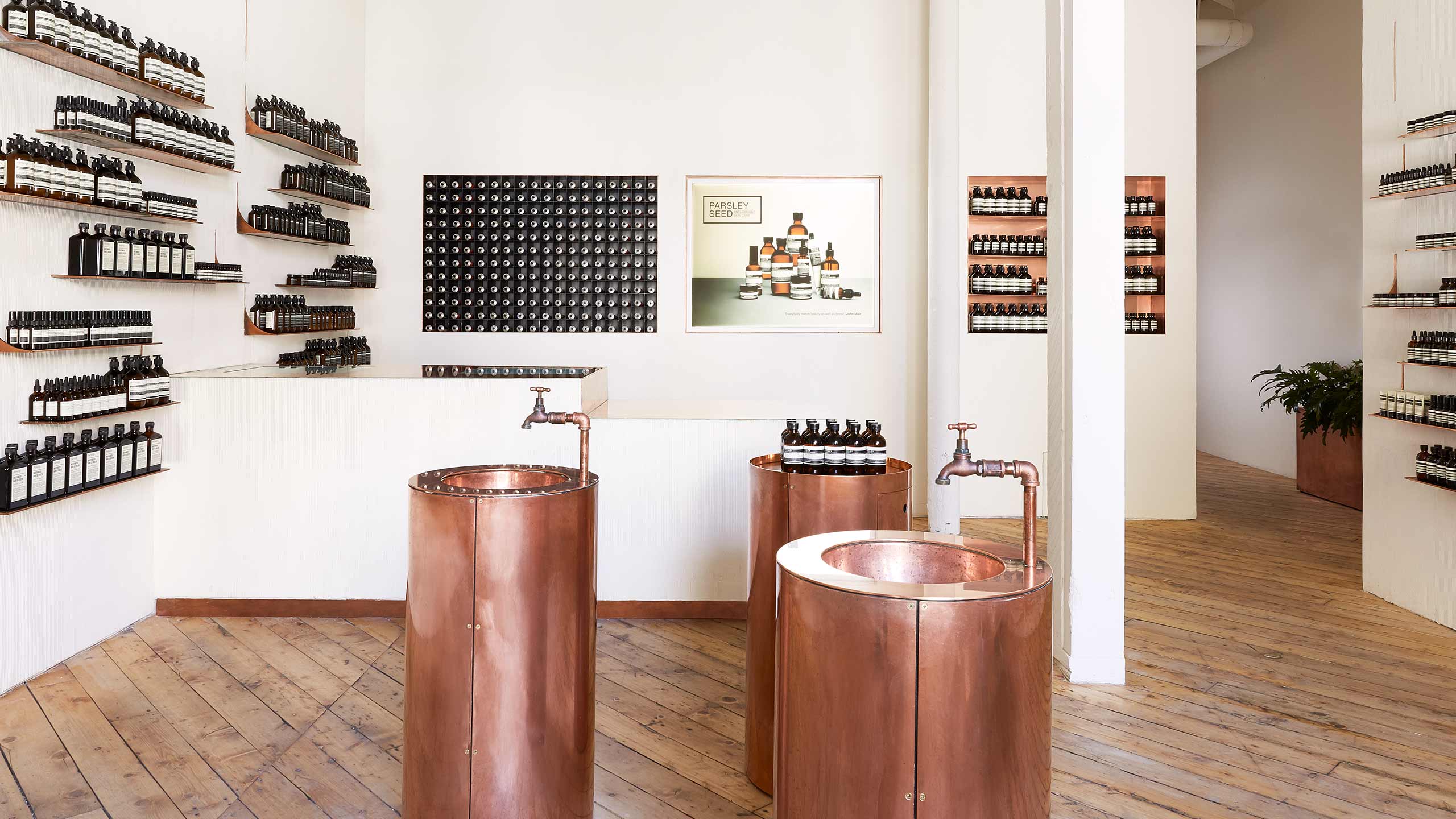 Store timber floor with brass sinks sitting in the centre. 