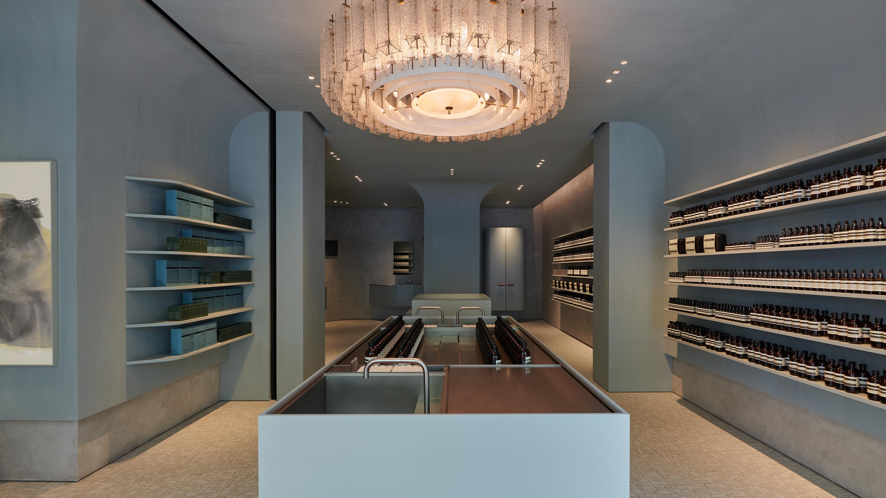  A monumental basin occupies the centre of the room, with Aesop products on two sides