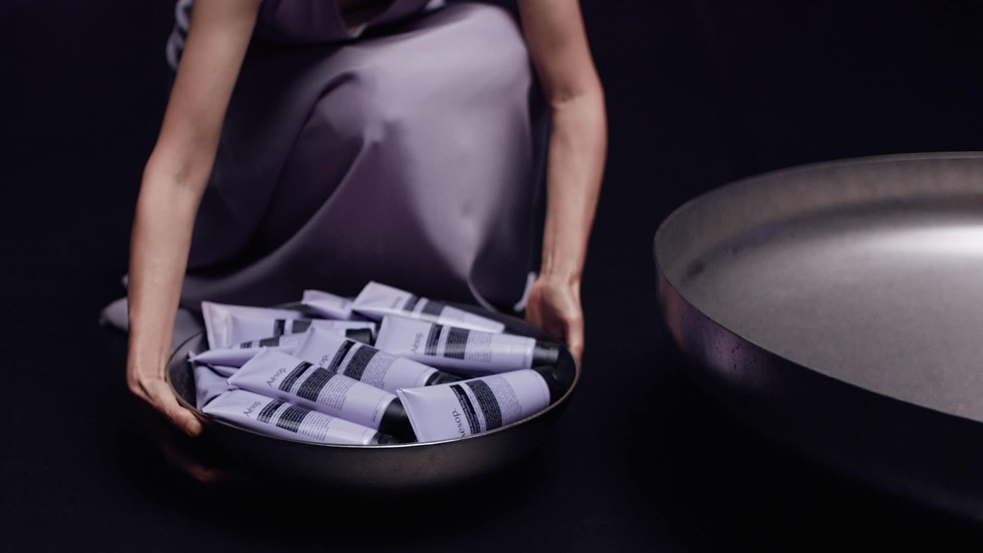 Eleos Nourishing Body Cleanser held in a metal bowl.