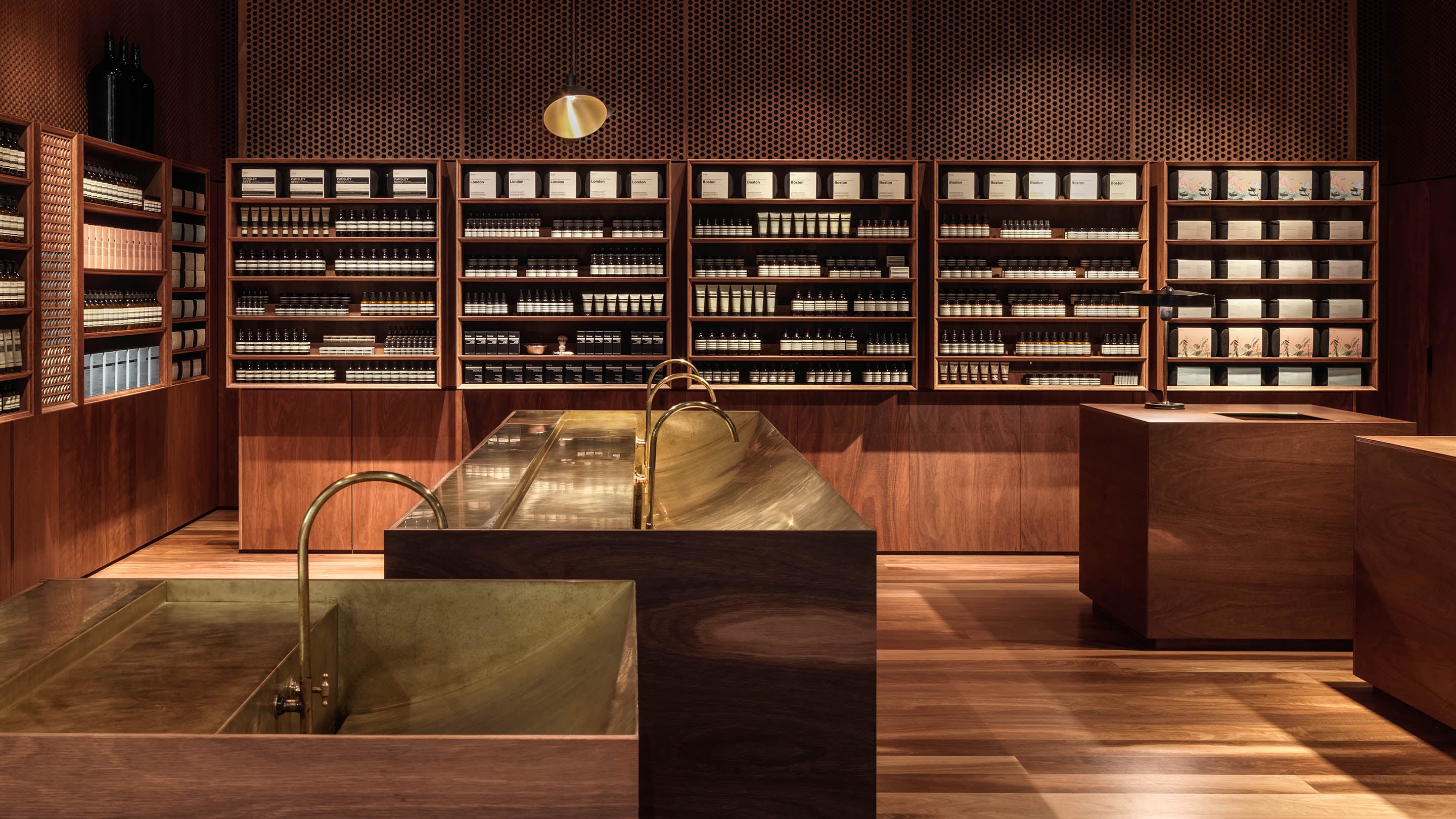 The stores interior is made from Spotted Gum flooring and shelving. The centerpiece of the store is the brass-detailed basin.