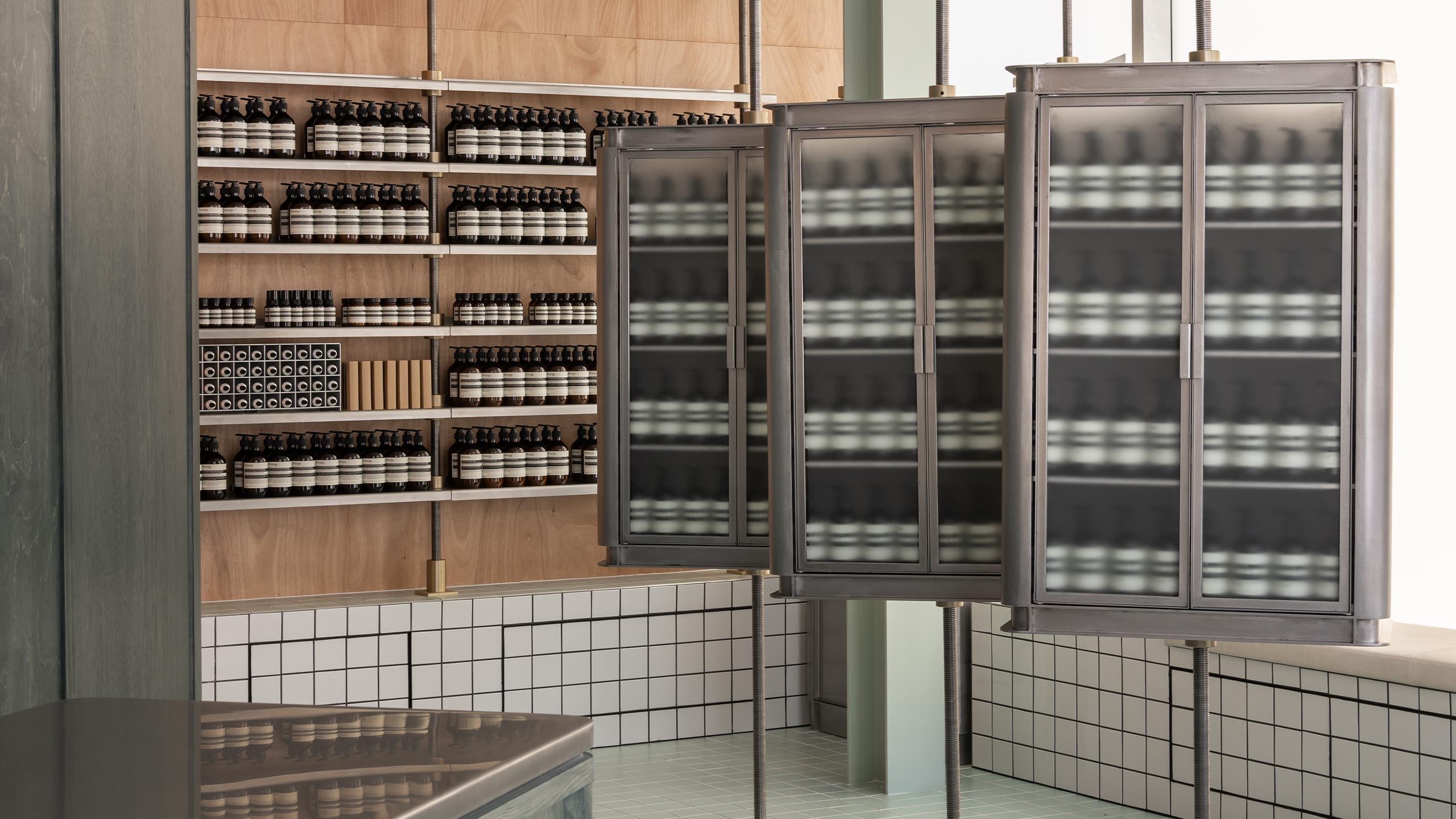 Aesop products on wooden shelves and metallic cabinets in Aesop Booragoon store