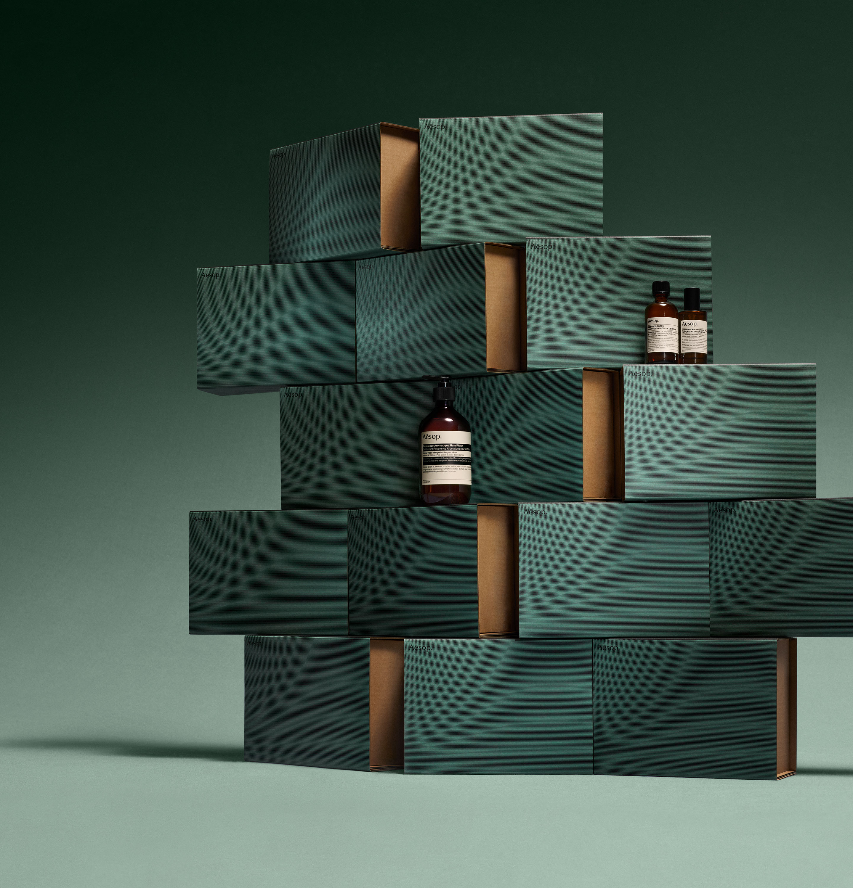 Aesop products placed on stacked blue cardboard boxes.